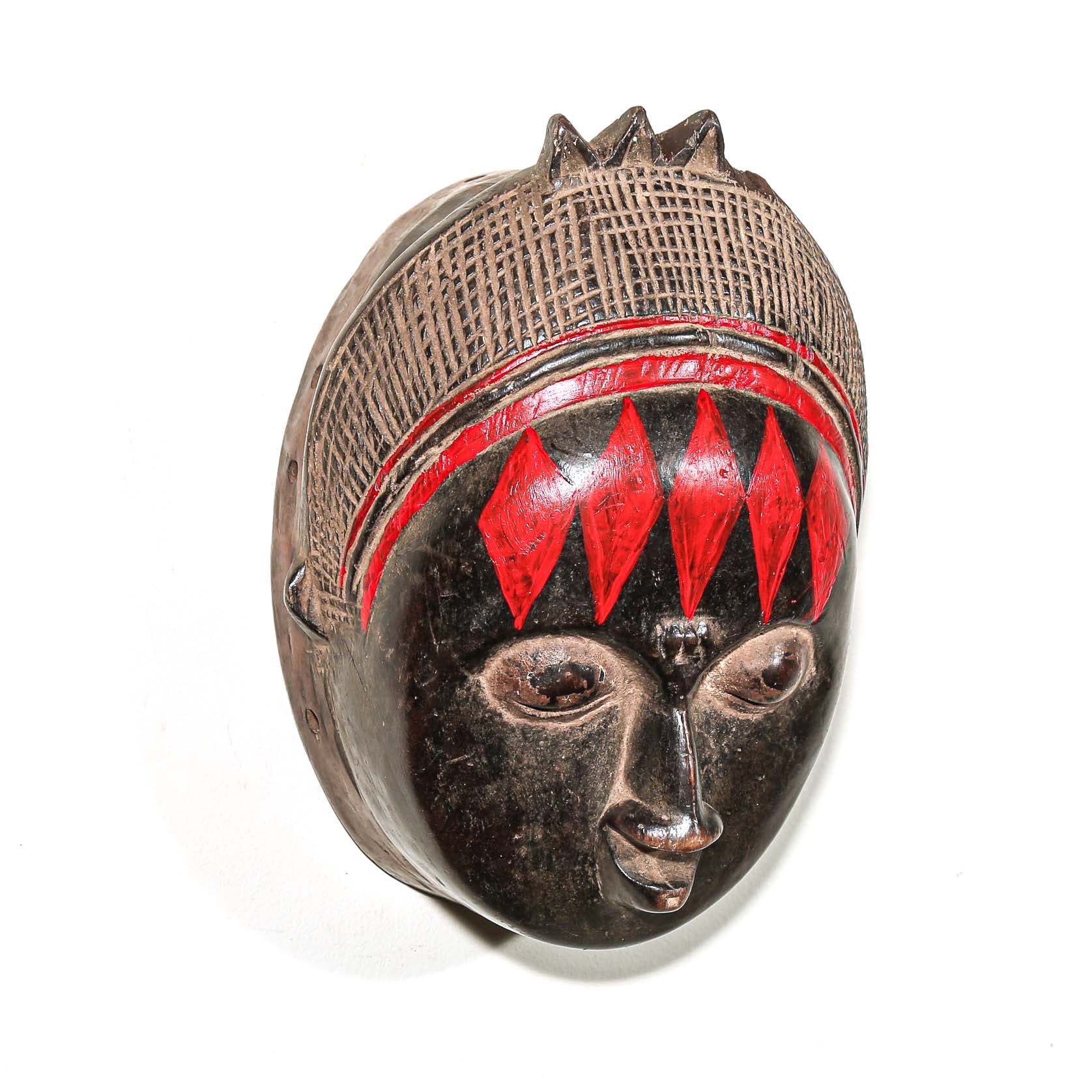 Decorative fine art african mask with red accents on a white background