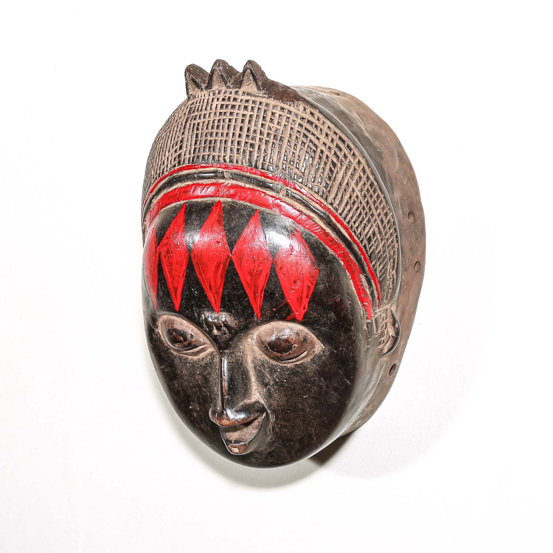 Decorative fine art african mask with red accents on a white background