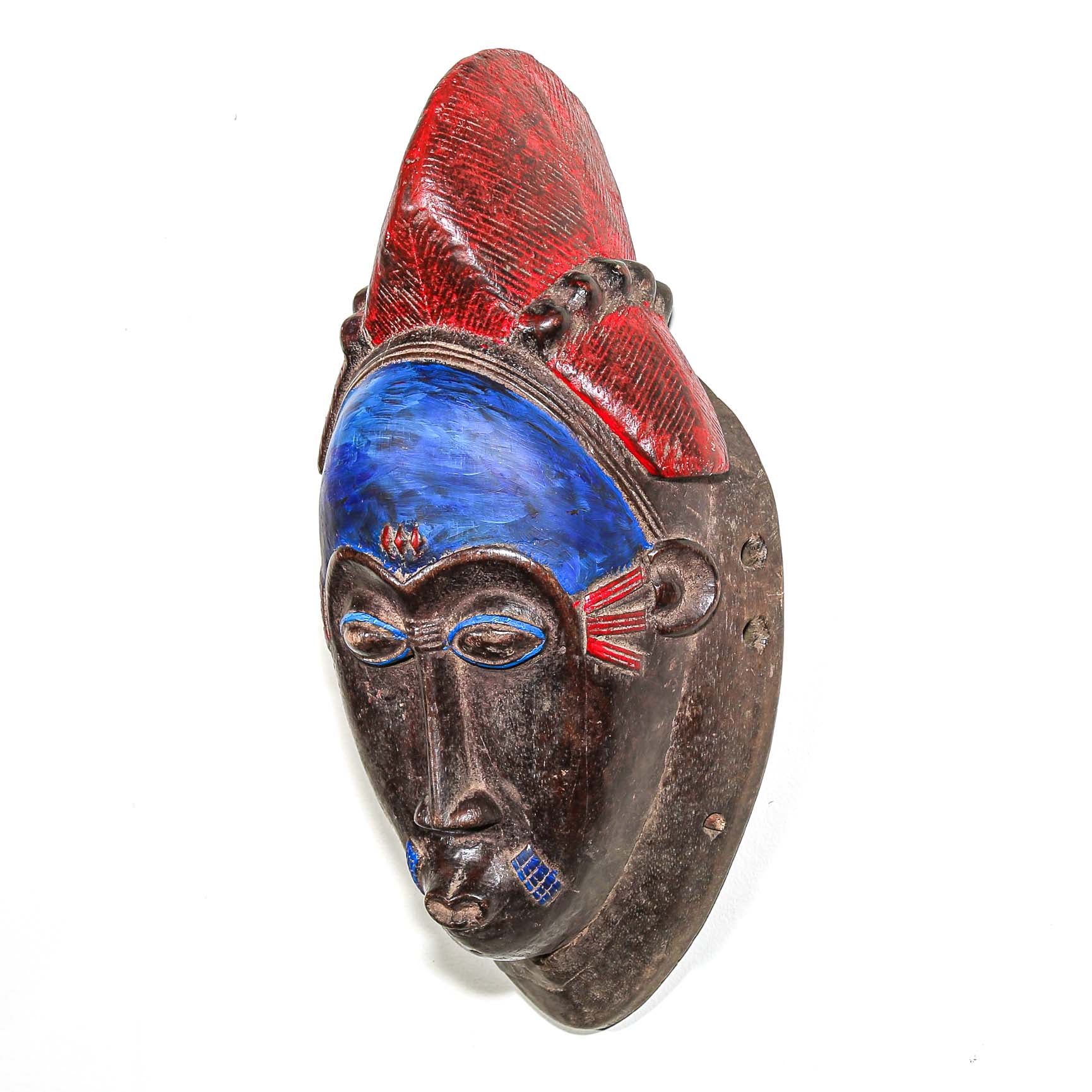 Decorative fine art african mask with red and blue accents on a white background