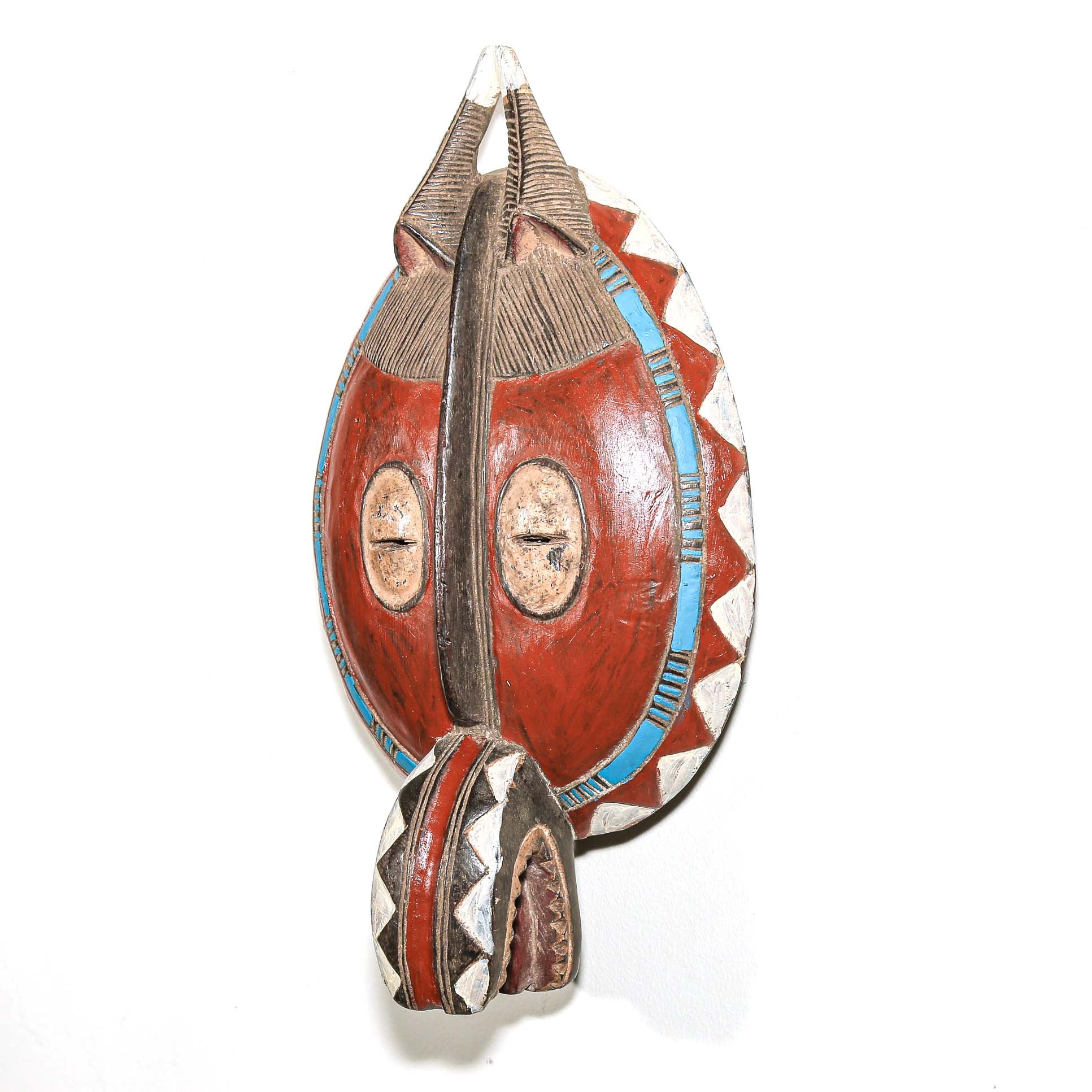 Traditional mask with red, blue, and silver colors on a white background. Colorful African art for sale