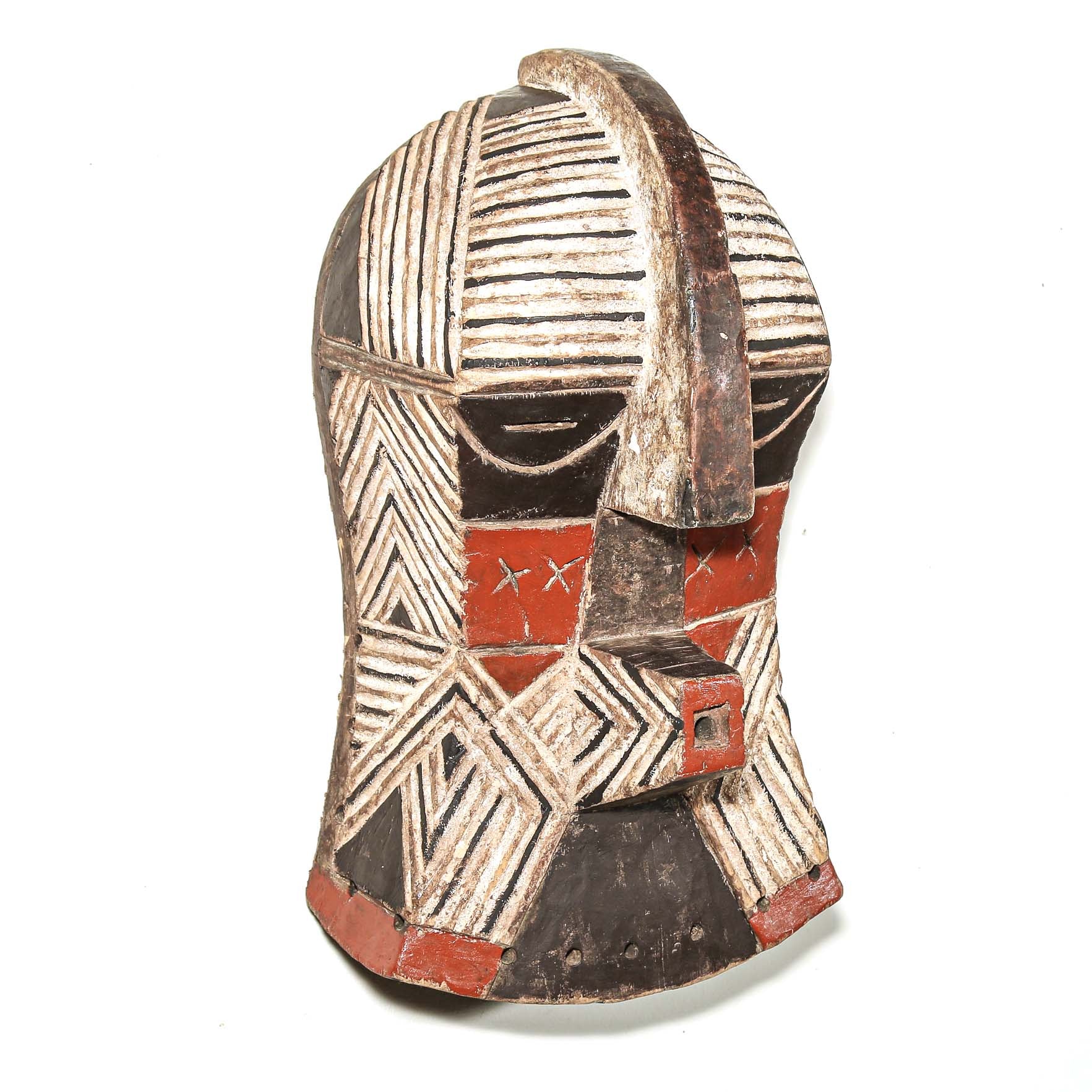 African art piece, specifically a wooden mask with geometric patterns on a white background. Tribal African art for sale.