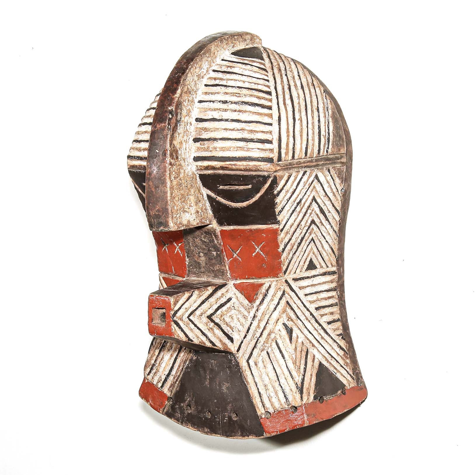 African art piece, specifically a wooden mask with geometric patterns on a white background. Tribal African art for sale.