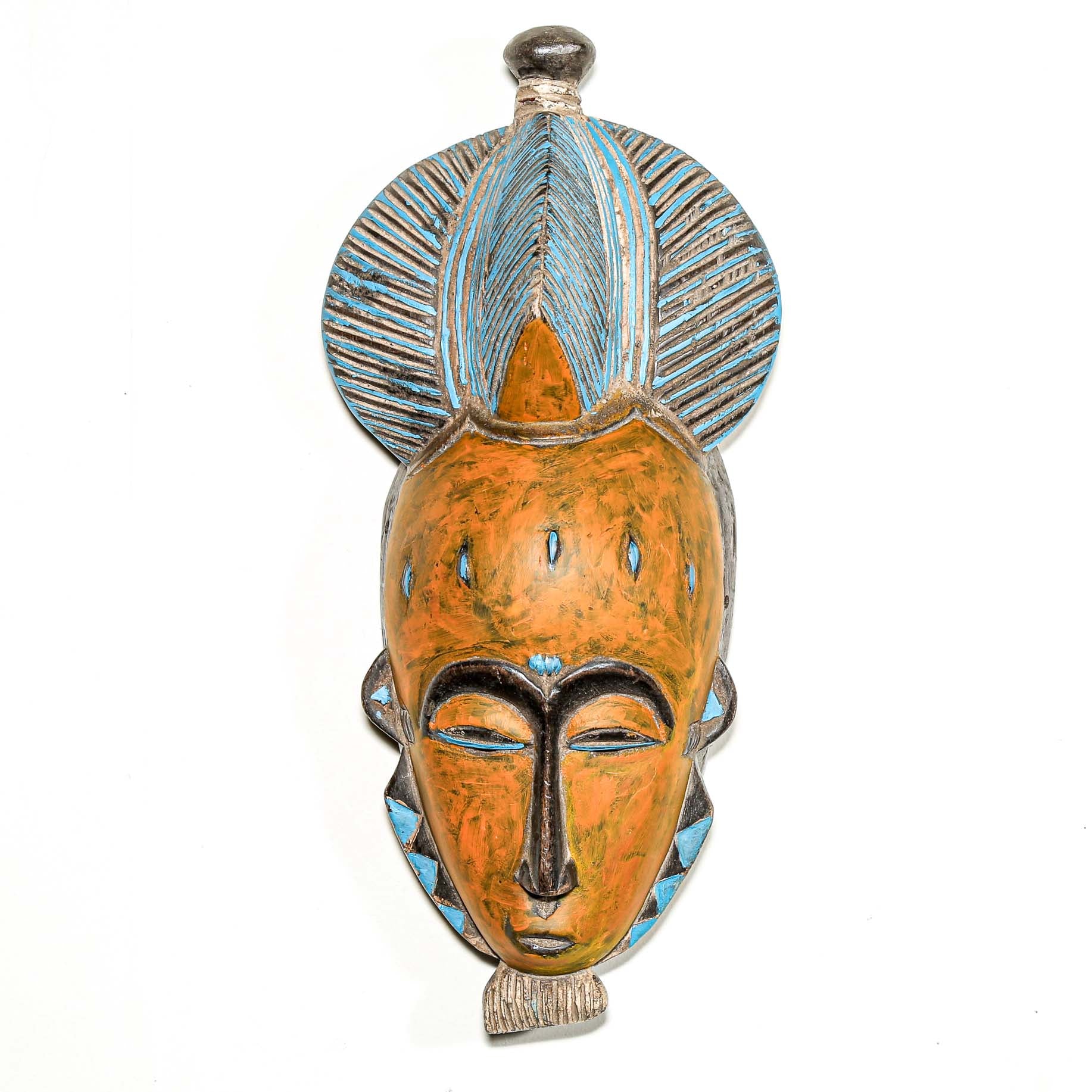 African art piece, specifically a yellow and blue wooden mask with geometric patterns on a white background. Tribal African art for sale.