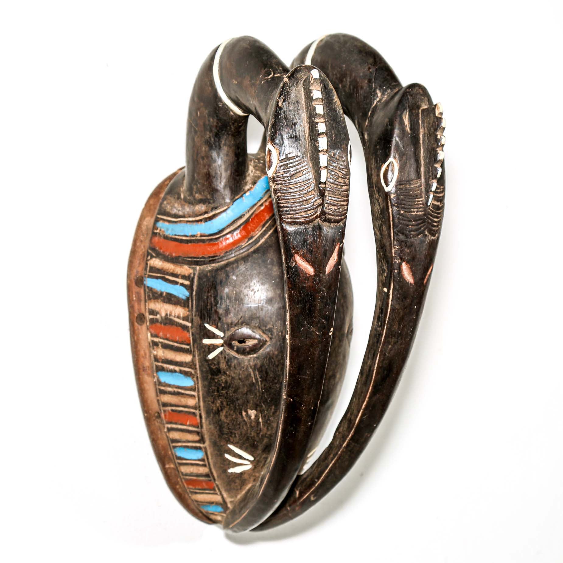 African art piece, specifically a yellow and blue wooden mask with geometric patterns on a white background. Tribal African art for sale.