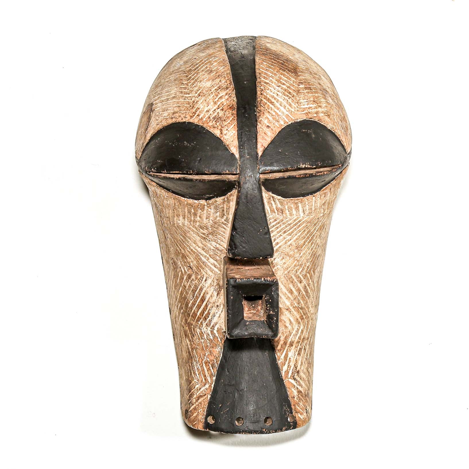 black and white Wooden african ceremonial mask with black accents on a white background