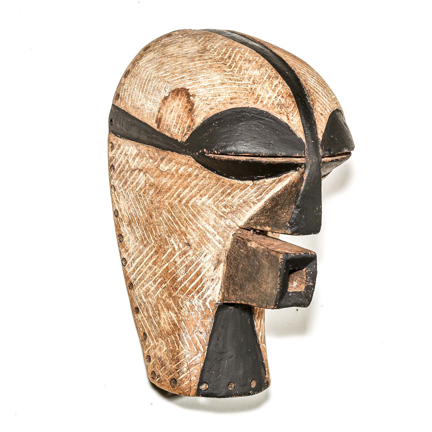 black and white Wooden african ceremonial mask with black accents on a white background