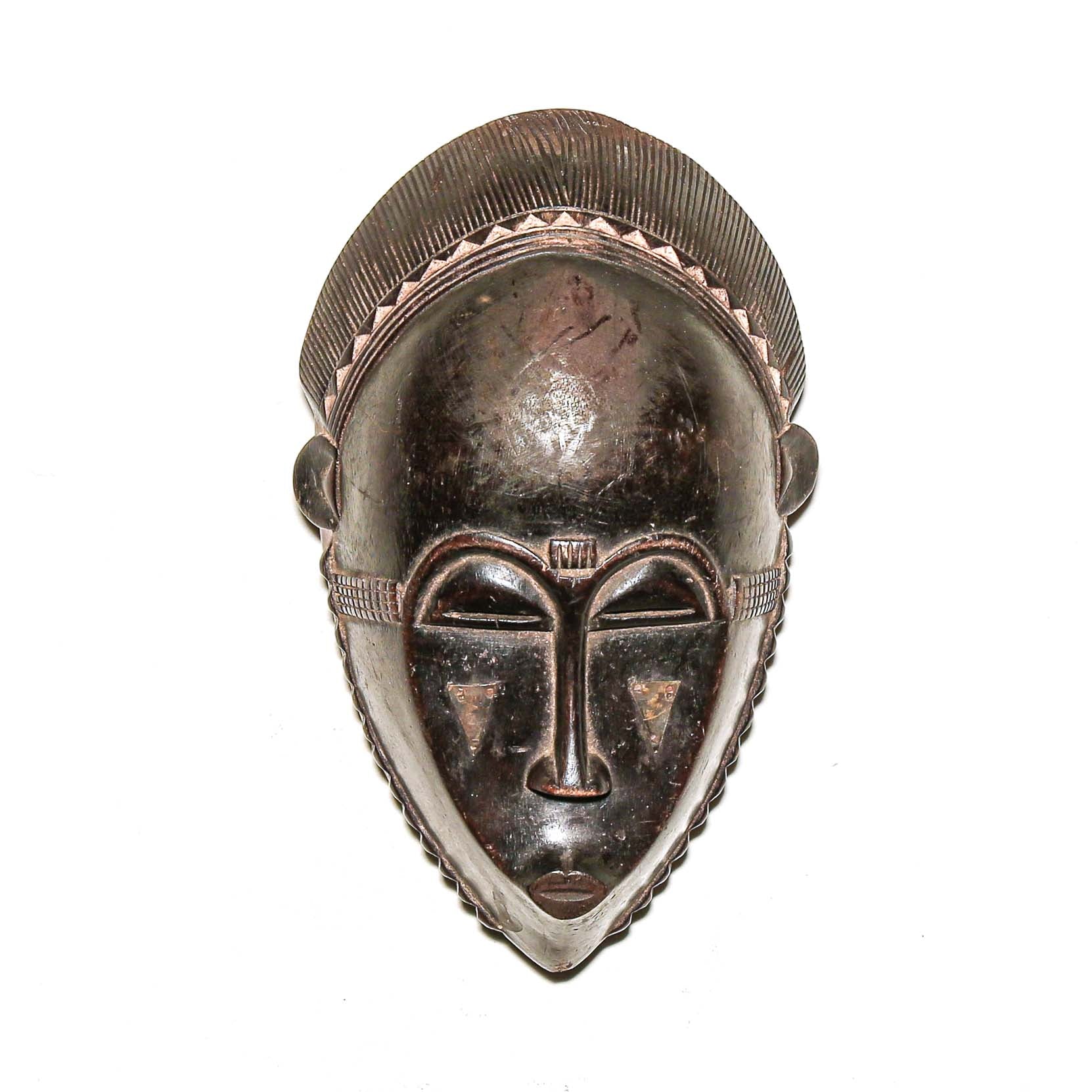 Wooden traditional African mask with black art face on a white background. Fine Art from Africa for sale