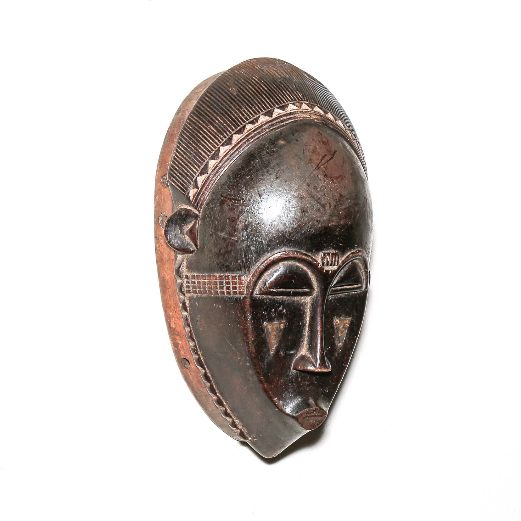 Wooden traditional African mask with black art face on a white background. Fine Art from Africa for sale
