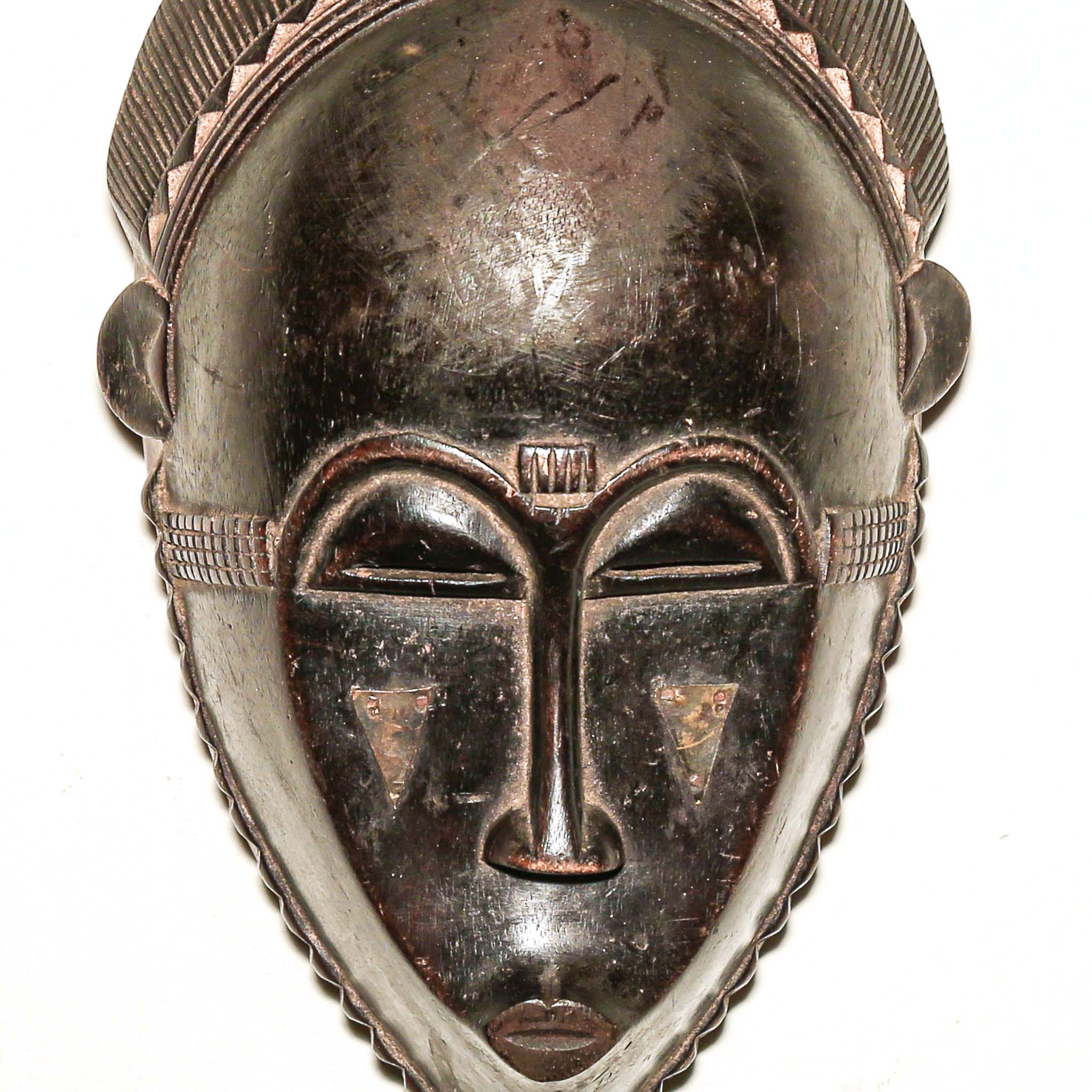 Wooden traditional African mask with black art face on a white background. Fine Art from Africa for sale