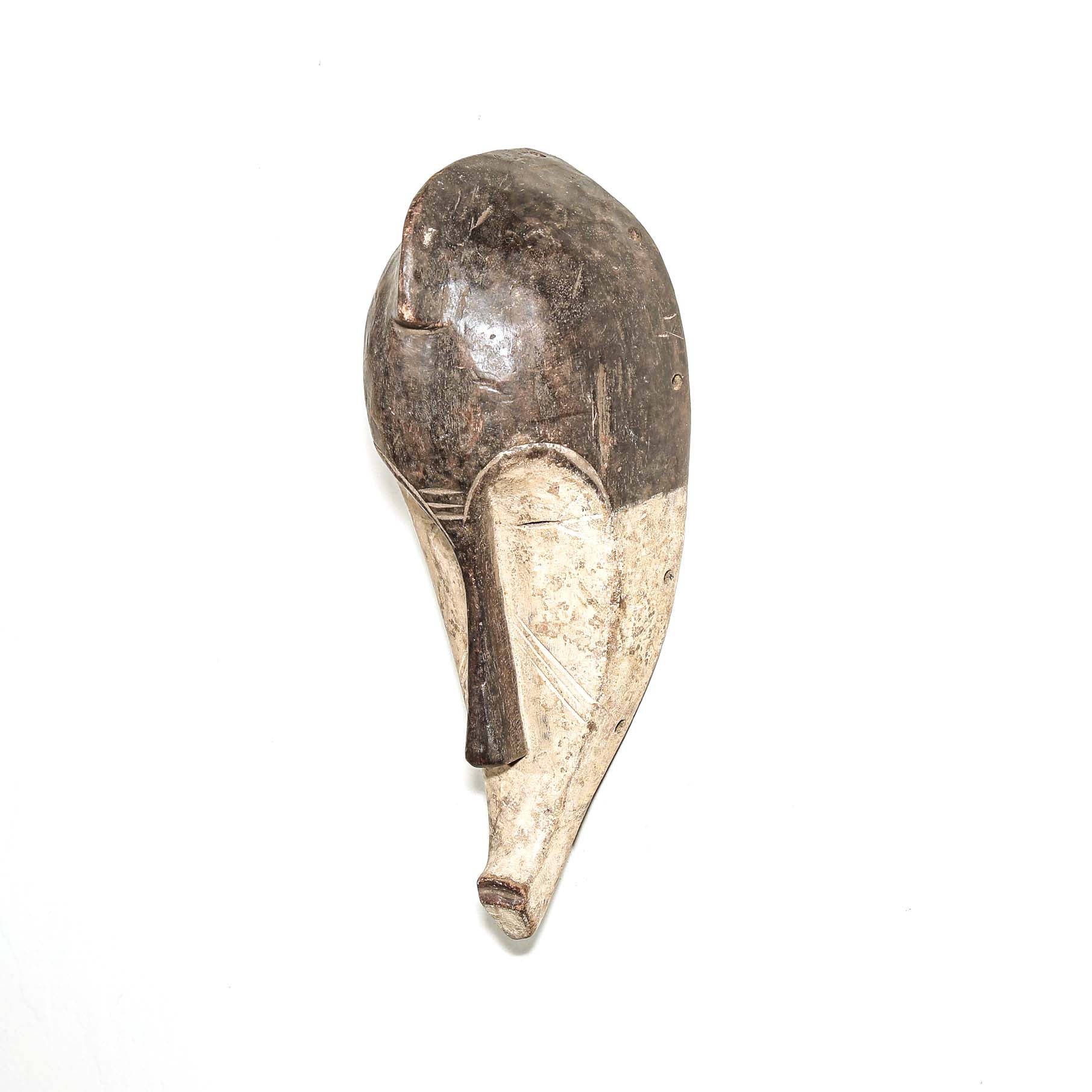 Wooden traditional African mask with black and white face on a white background. Fine Art from Africa for sale