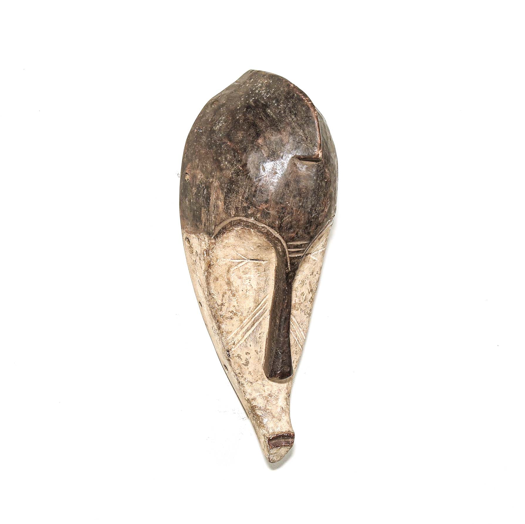 Wooden traditional African mask with black and white face on a white background. Fine Art from Africa for sale