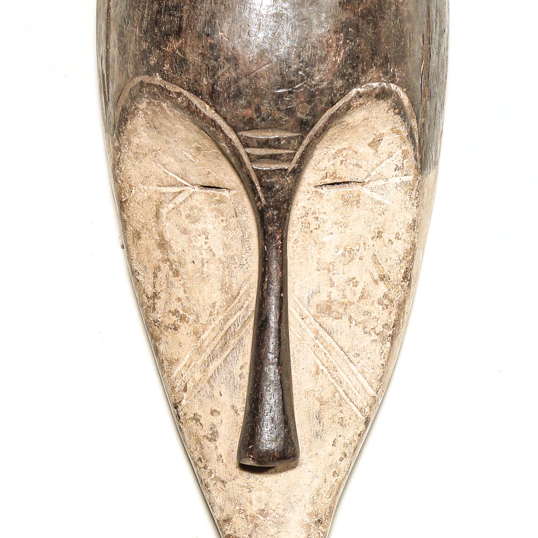Wooden traditional African mask with black and white face on a white background. Fine Art from Africa for sale
