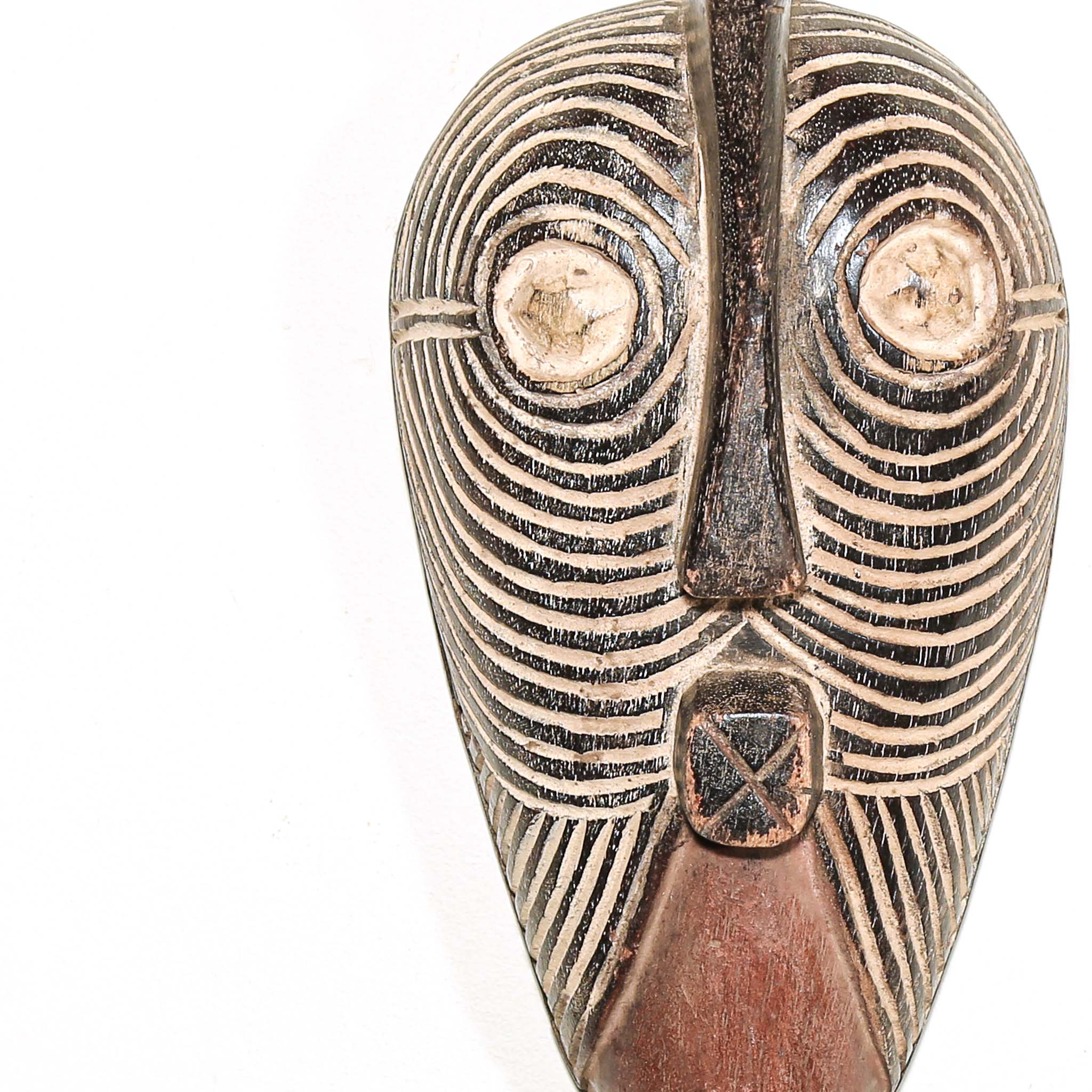 Wooden traditional African mask with black and white face on a white background. Fine Art from Africa for sale