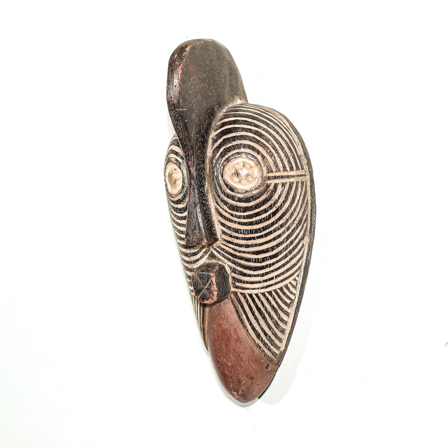 Wooden traditional African mask with black and white face on a white background. Fine Art from Africa for sale