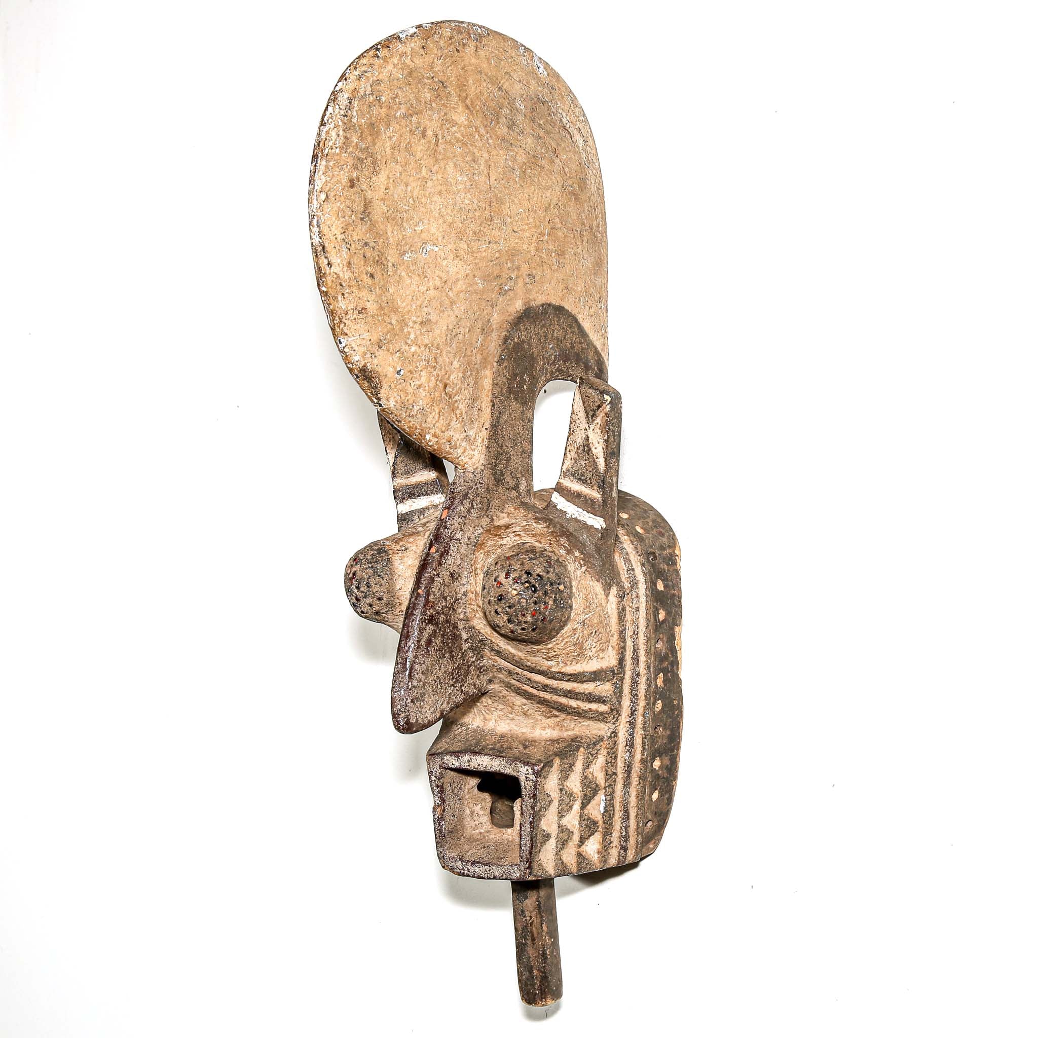 wood African mask black art colors hanging on a bedroom wall. African art for sale for collectors