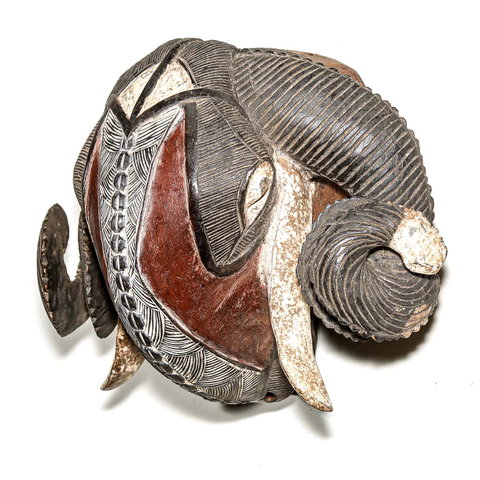 high end African ram's head sculpture with intricate patterns on a white background