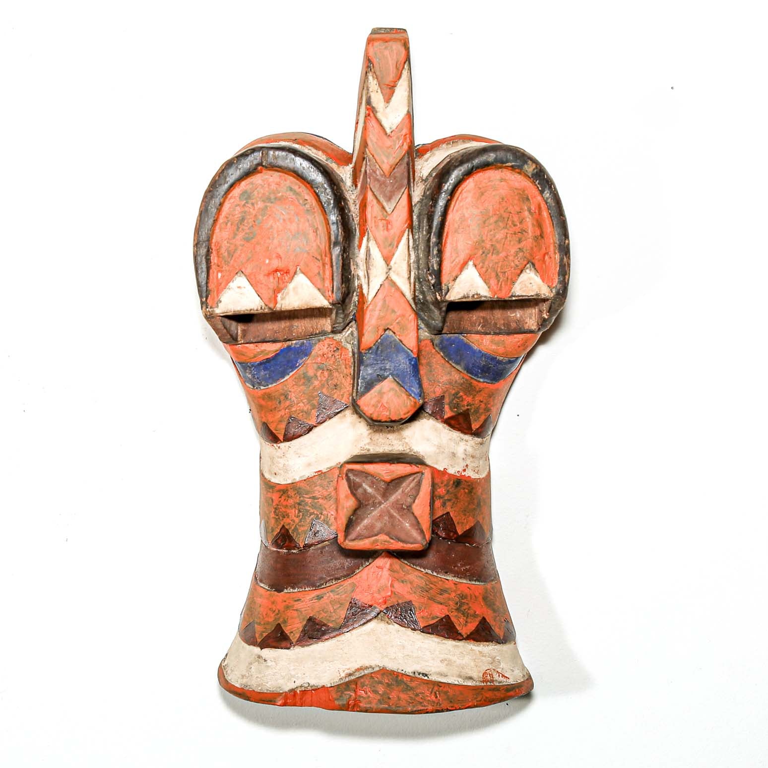 Ceramic sculpture with geometric patterns on a white background
