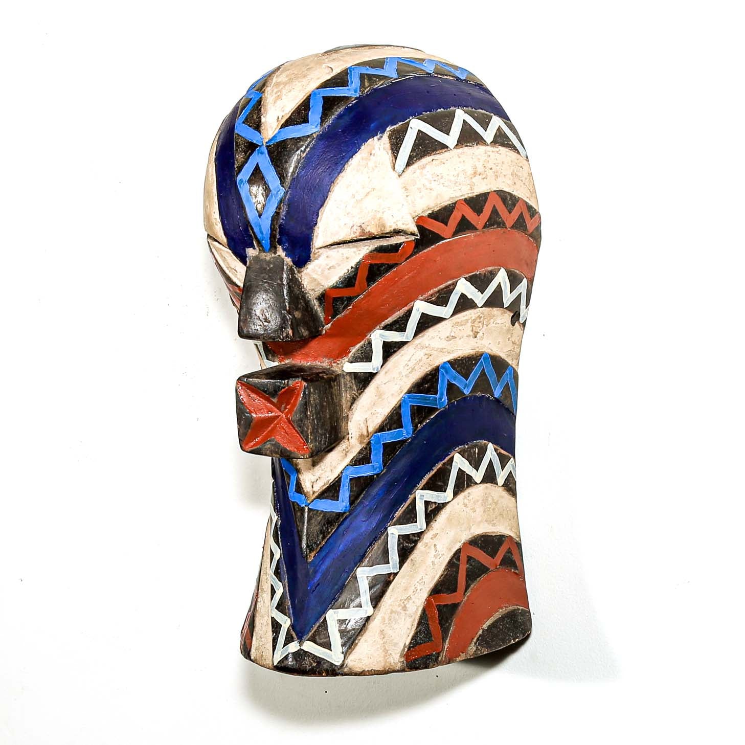 Colorful modern tribal art from African for sale. Songye ceremonial mask hanging on a white wall