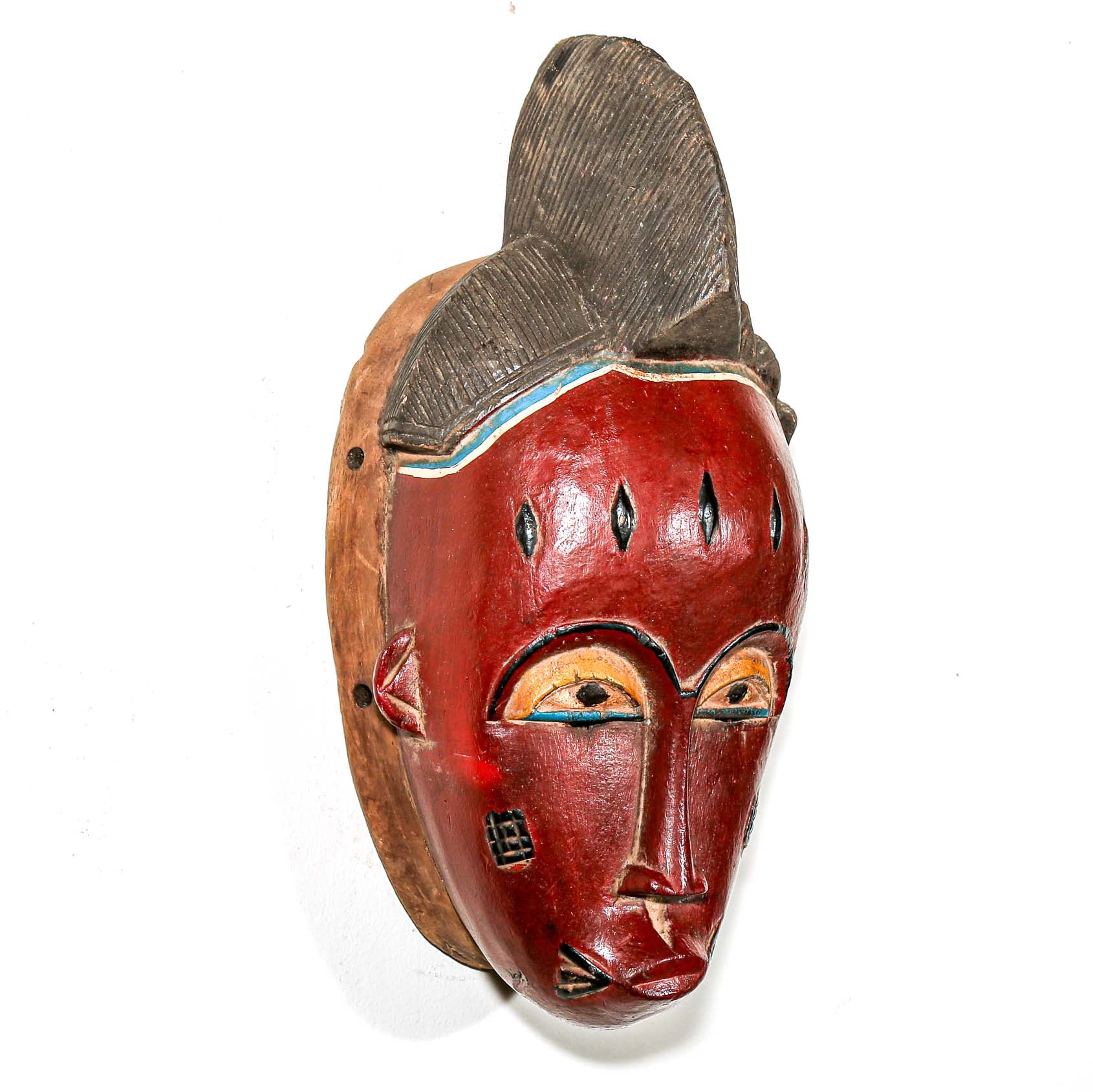 Wooden mask with red face and brown wooden frame on a white background