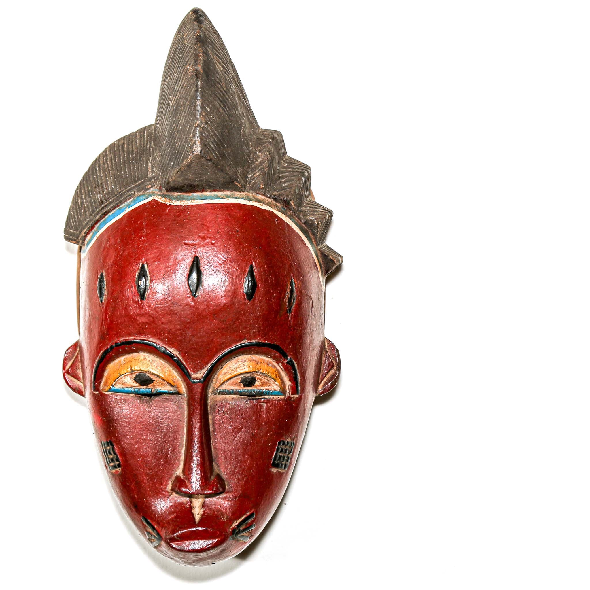 African-style mask with red face and decorative headdress on a white background