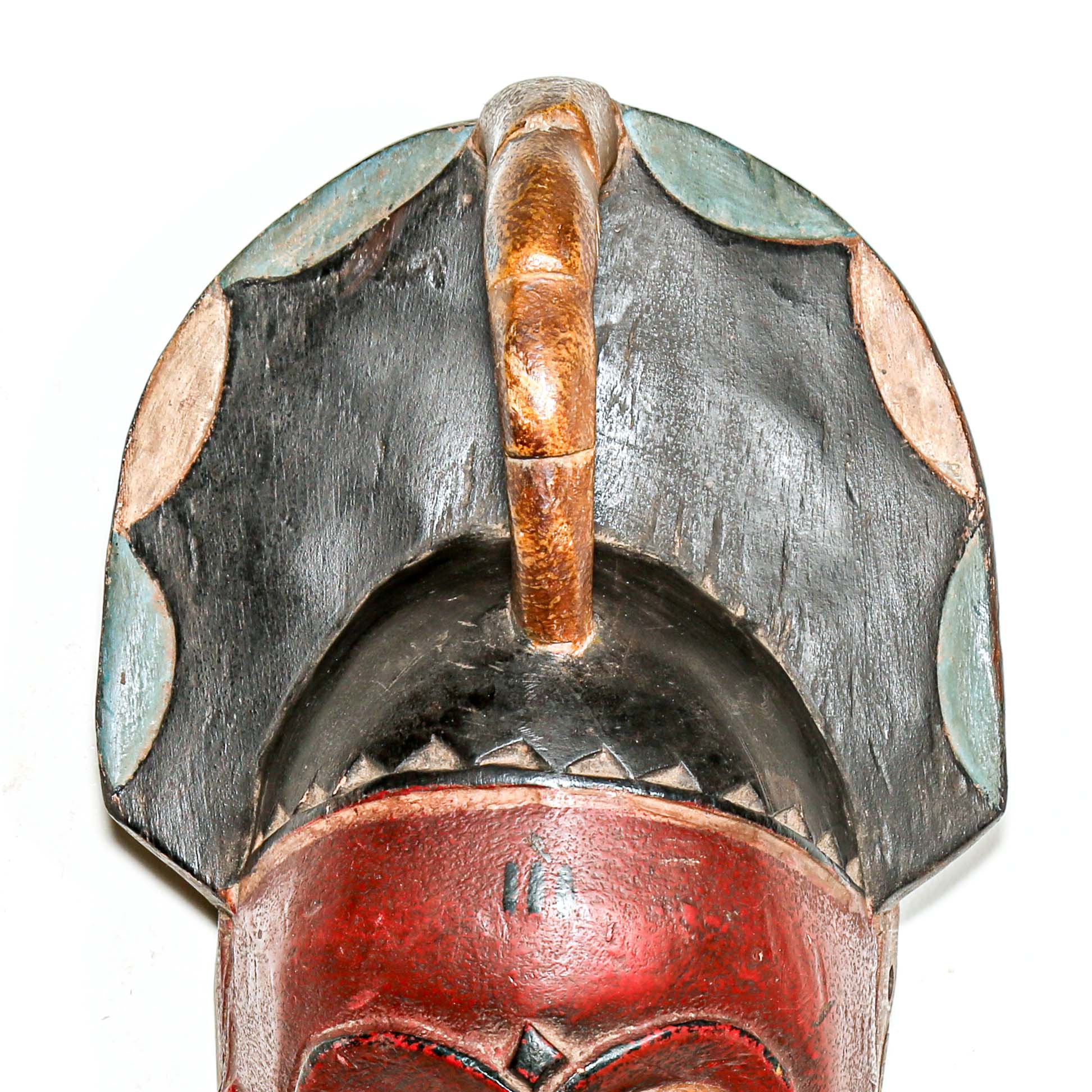 Red collectable African tribal mask for modern interior design ideas