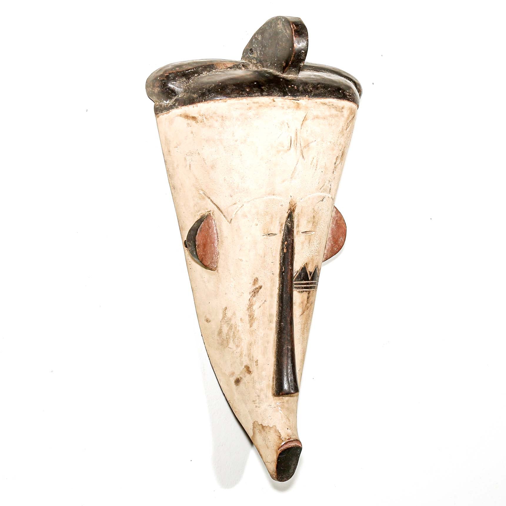 white hand carved wood Fang tribe wall mask with tribal designs on a white background