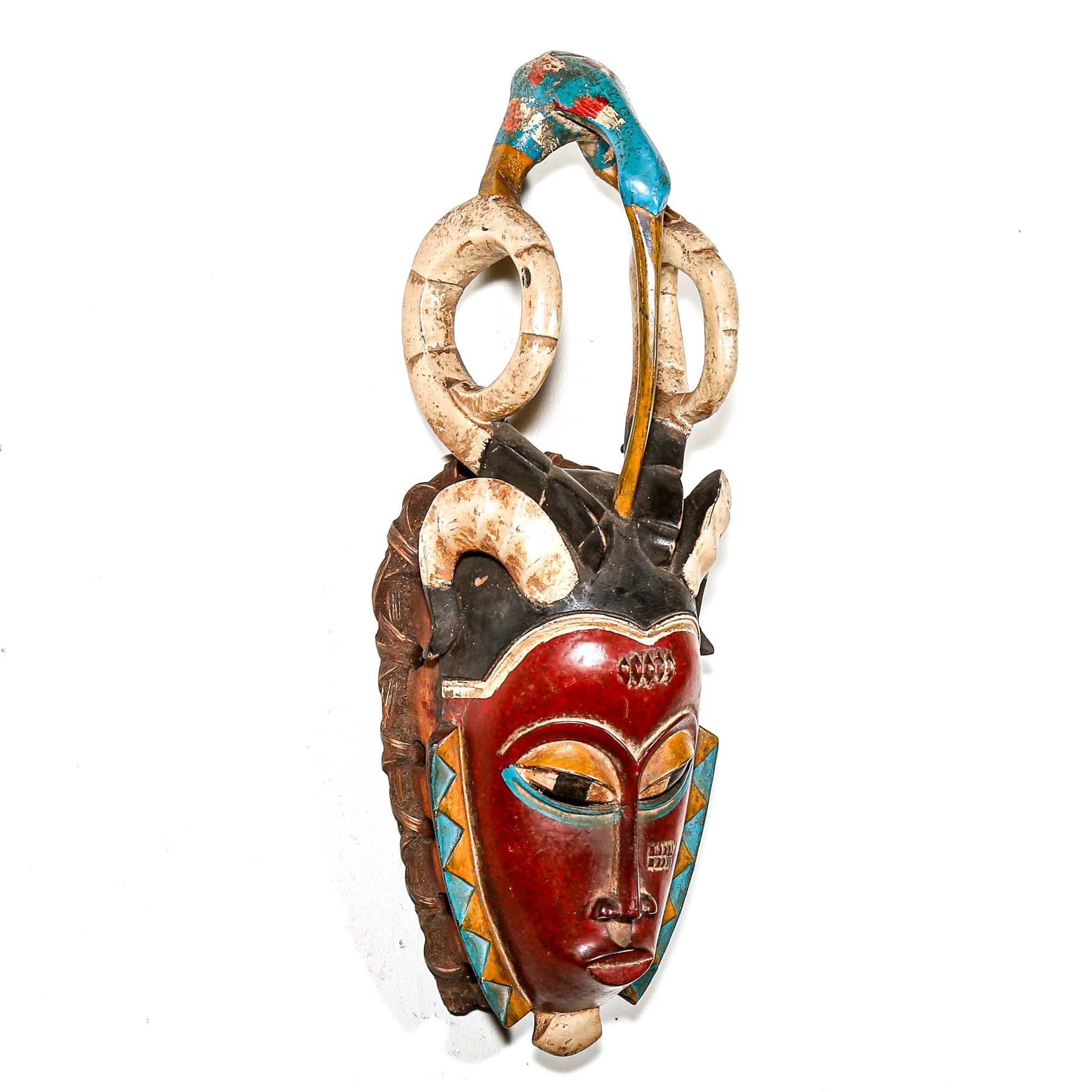Decorative mask with intricate designs on a white background