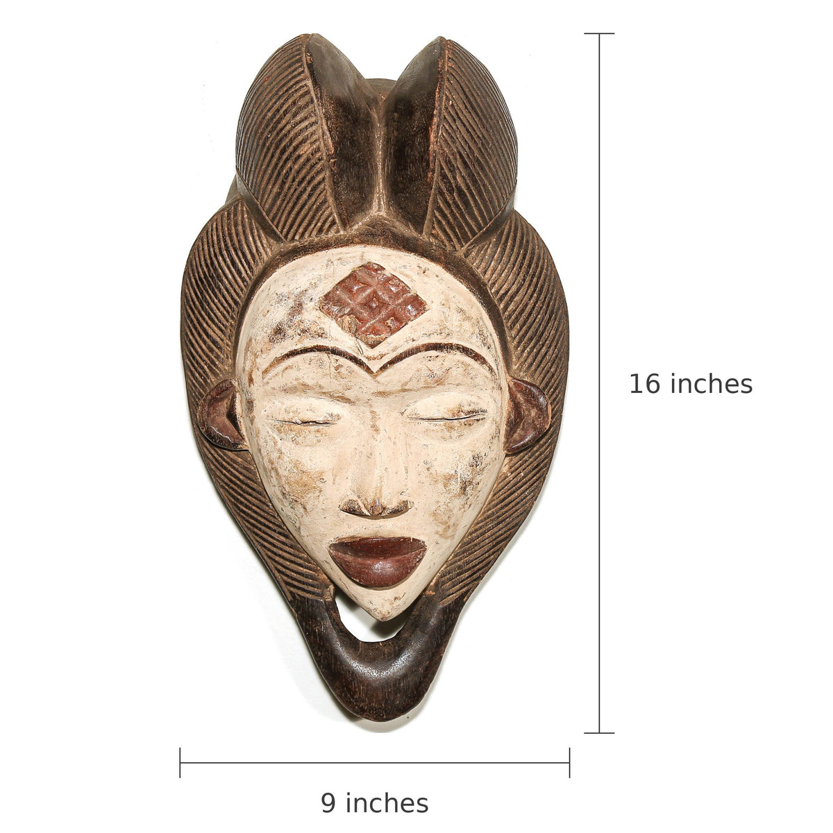 A carved decorative face mask with closed eyes, dark brown hair details, and a light beige face, shown with dimension markers indicating 16 inches tall and 9 inches wide on a white background.