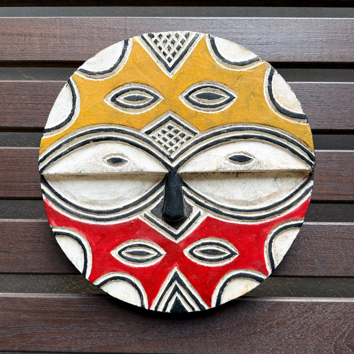 Decorative Teke mask from Congo with bold carved facial features and graphic painted details for African wall decor