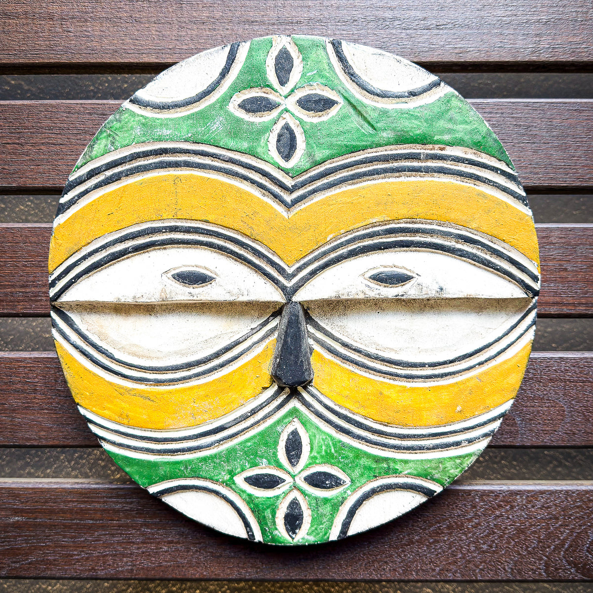 Round Teke Kidumu mask from the Democratic Republic of Congo with bold geometric patterns and a distinctive circular form