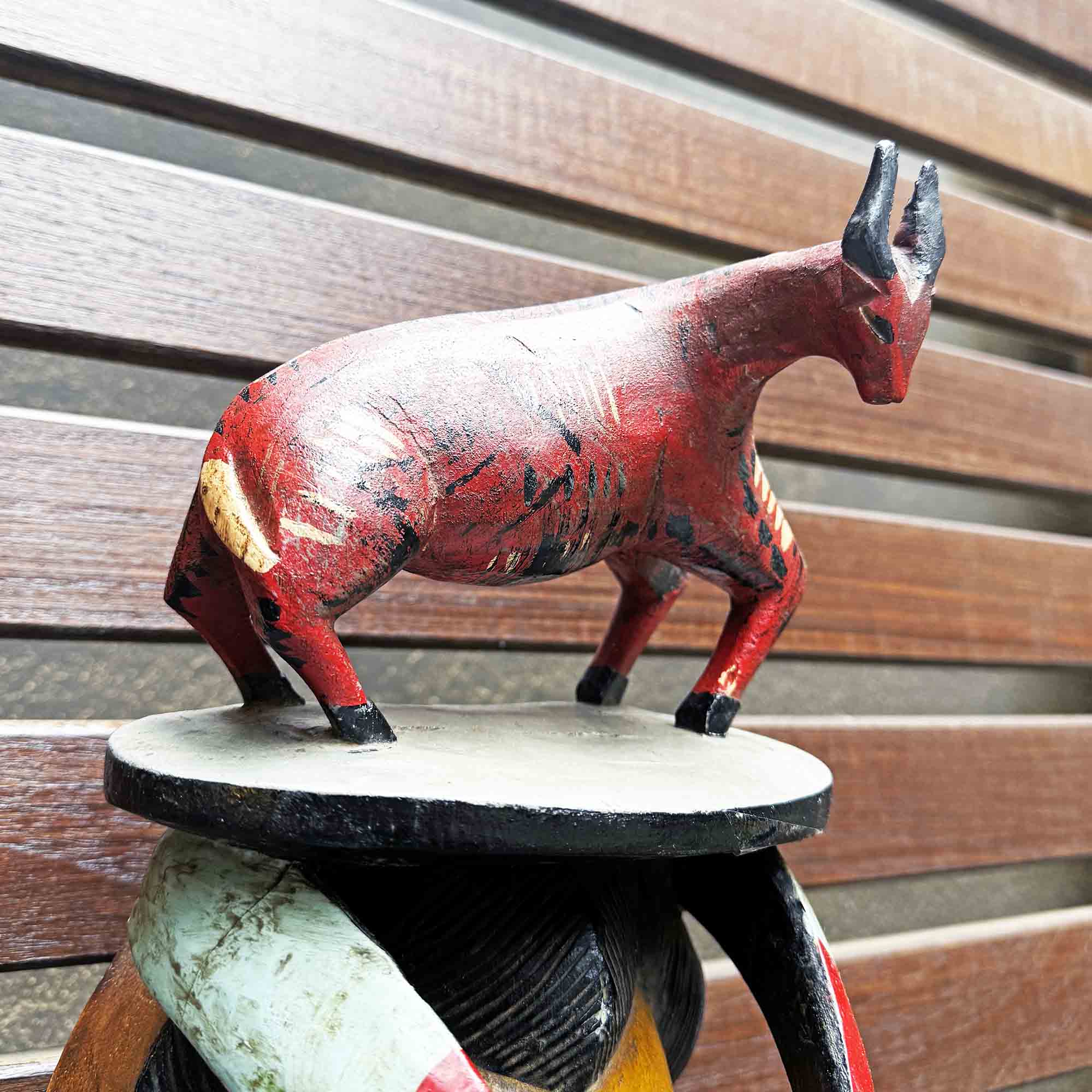 Detail of African bull on the head in a mask from Africa handing on a wall