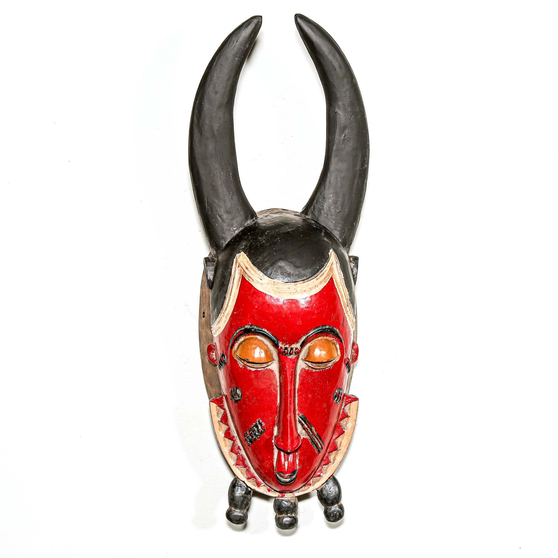 Red and black horned mask on a white background