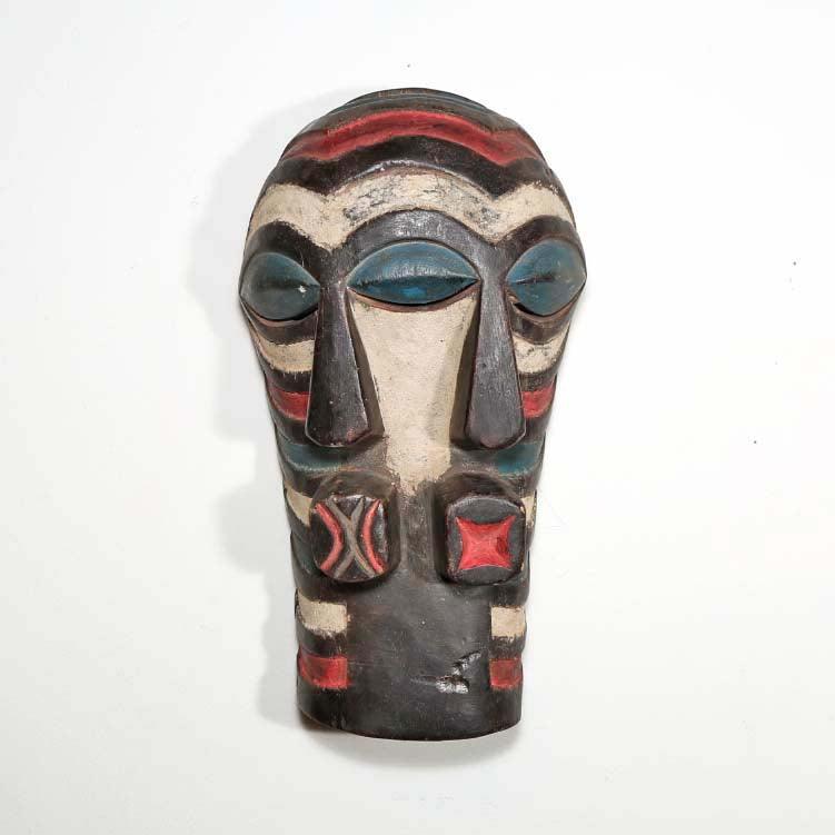 Songye Style Mask from D.R. Congo hung on a wall