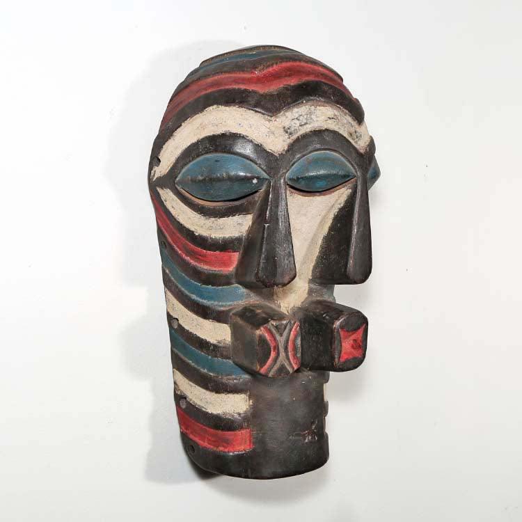 Songye Style Mask from D.R. Congo hung on a wall showing right side