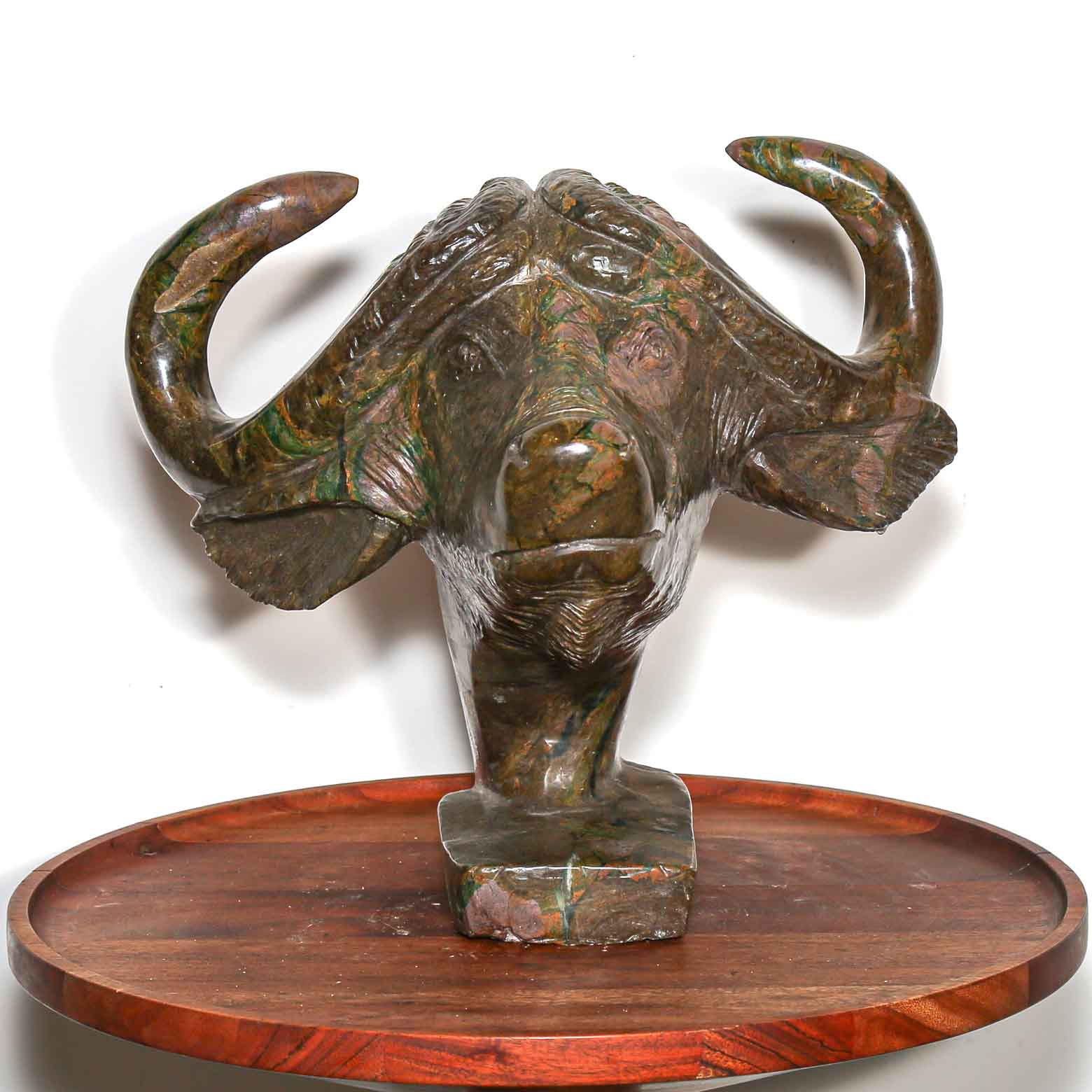 Sculpture of a buffalo from the front. In hand carved and handmade stone