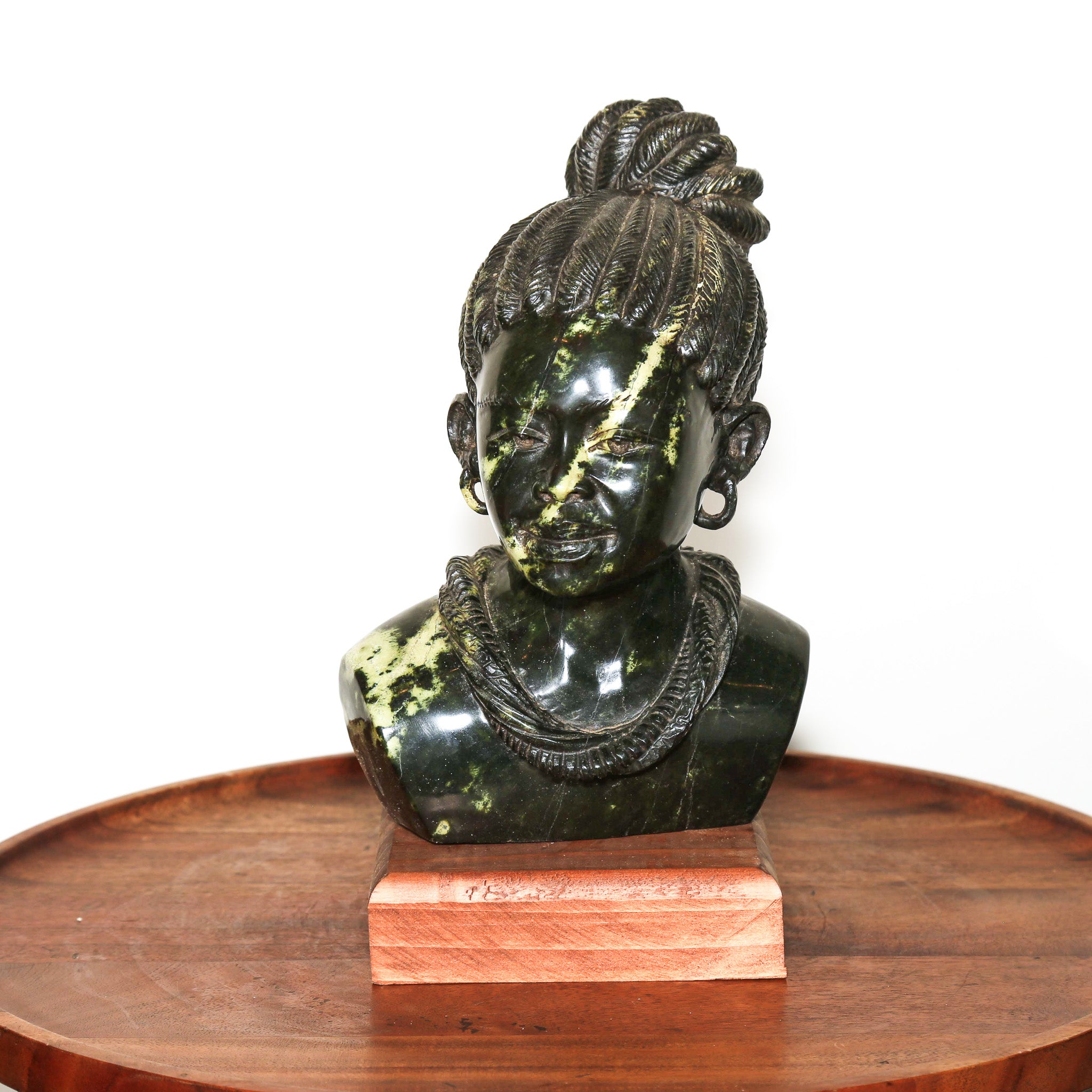 black and green stone feminine statue