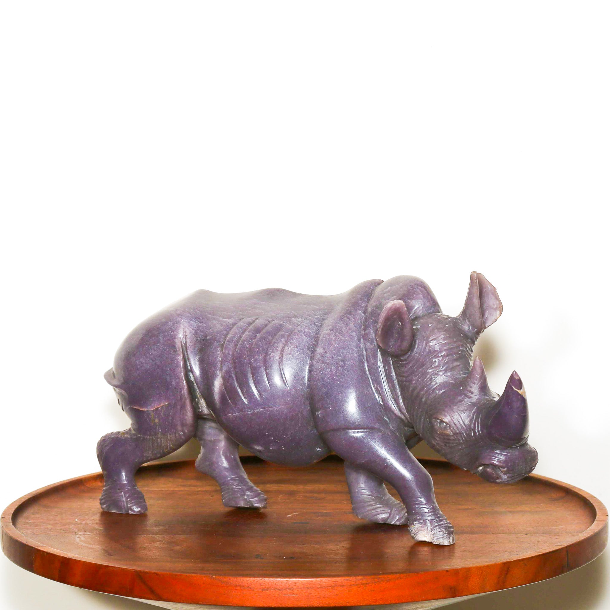 purple stone sculpture of a rhinoceros