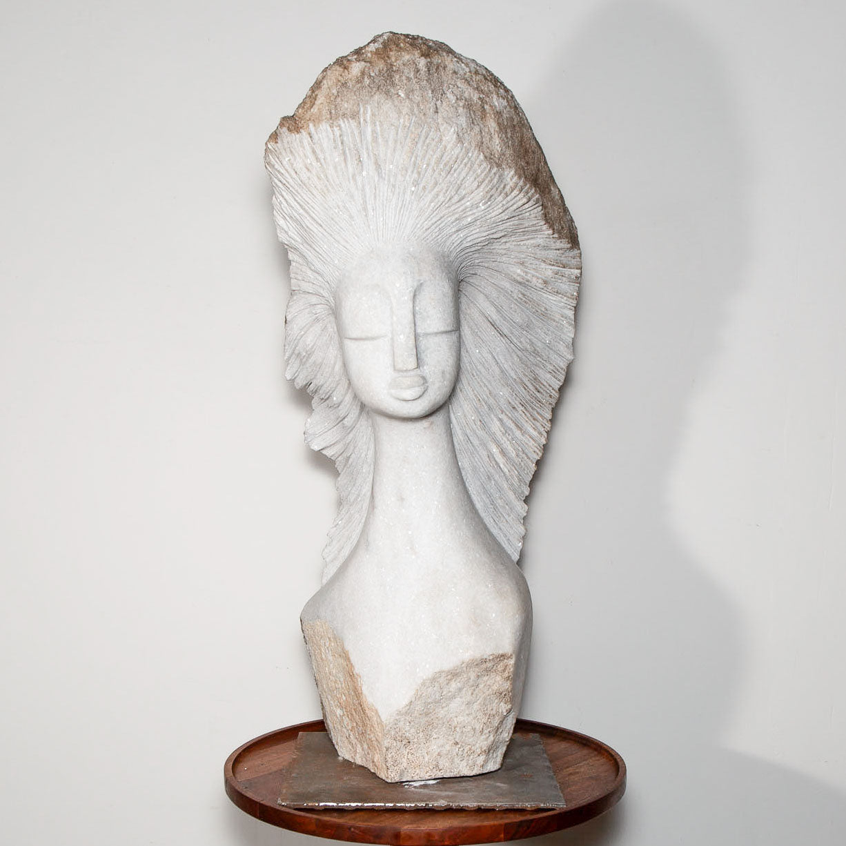 white stone sculpture of a woman