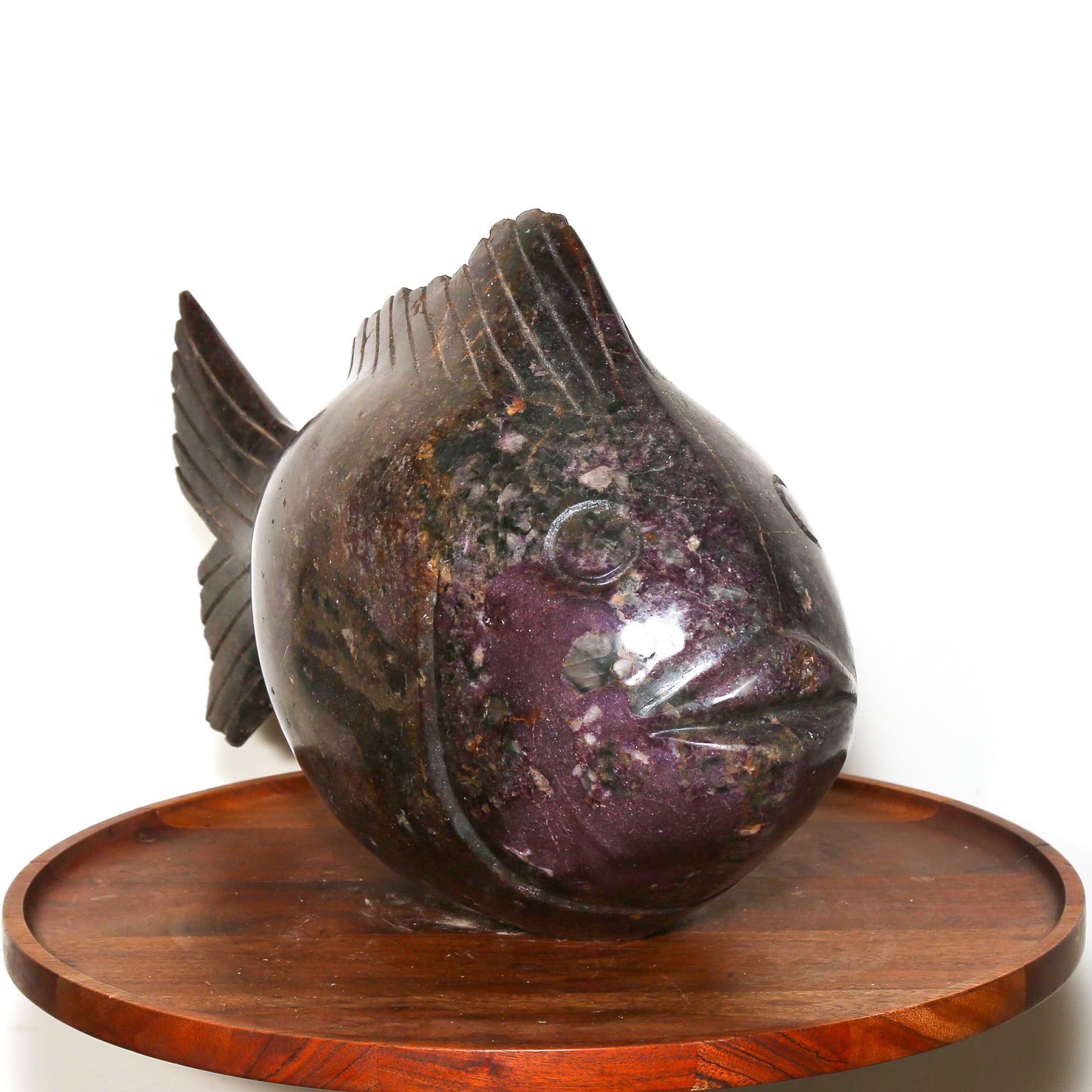 purple carving of a stone fish