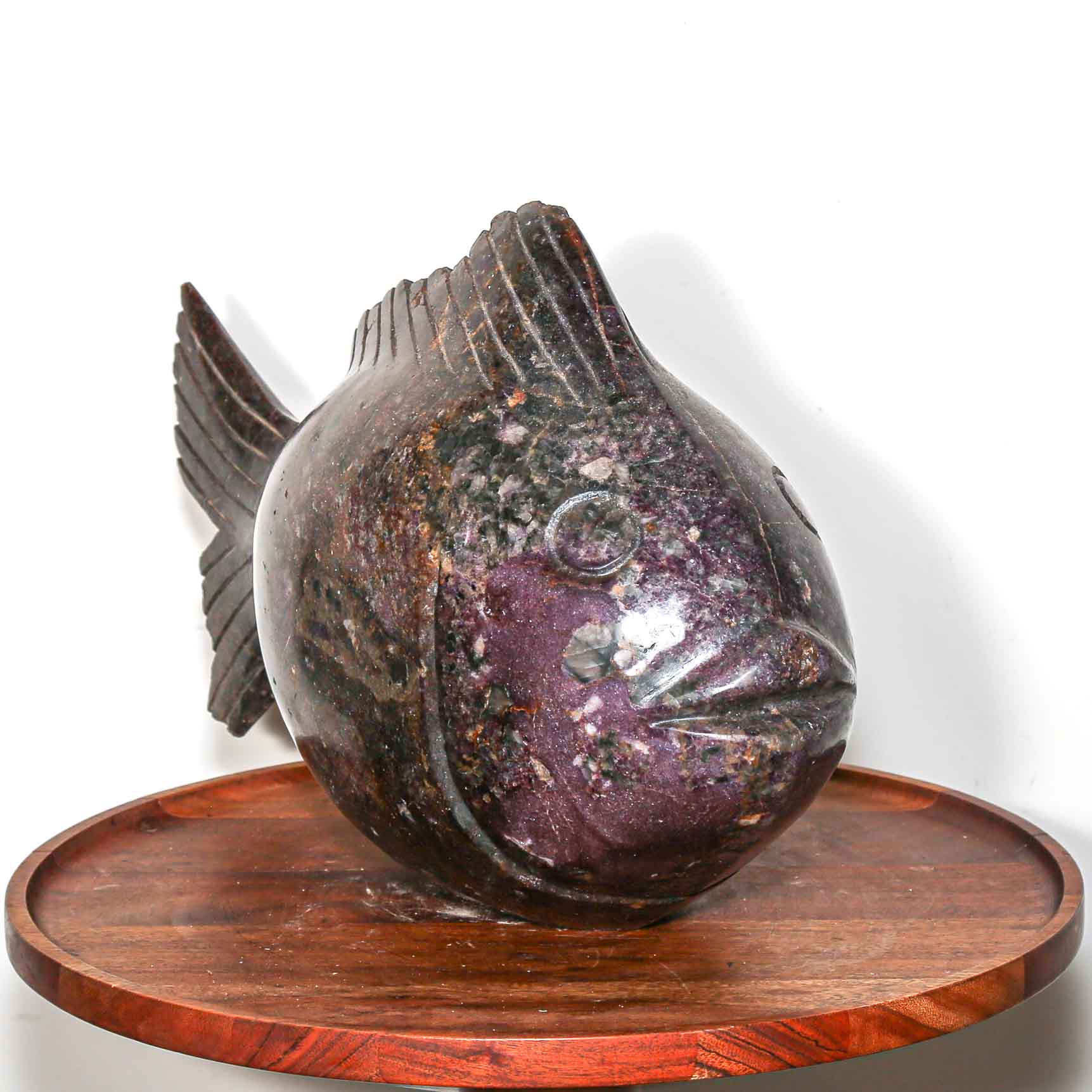 Purple stone sculpture of a fish