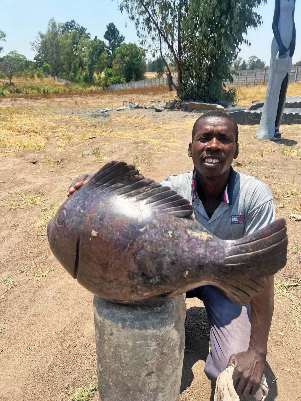 African artist with his sculpture