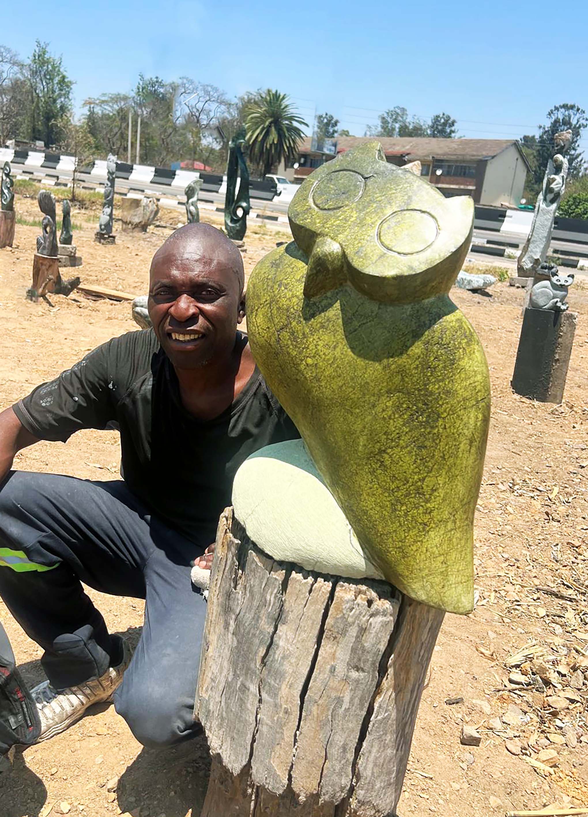 Sculpture of owl with it's artist from Africa