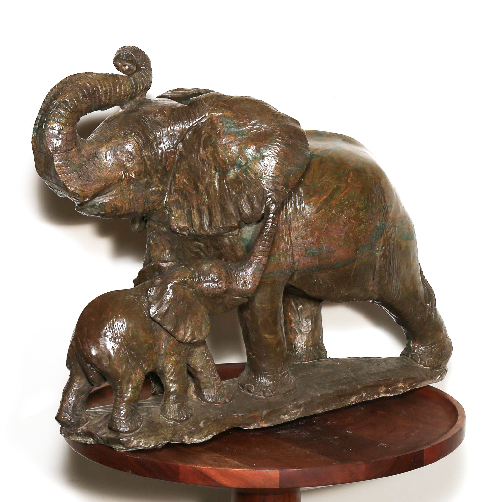 Green sculpture of African elephant with baby