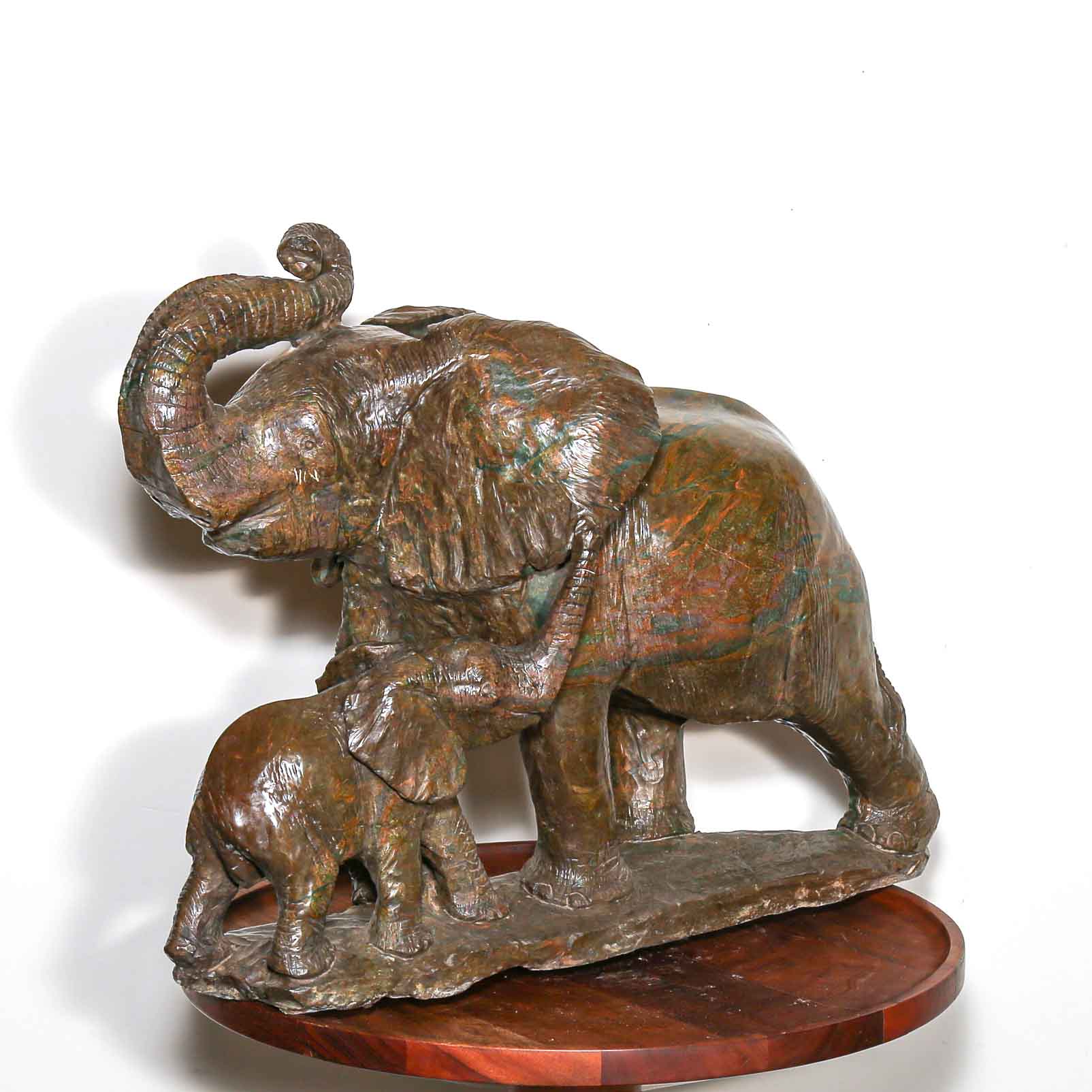 Green stone sculpture of African elephant with baby