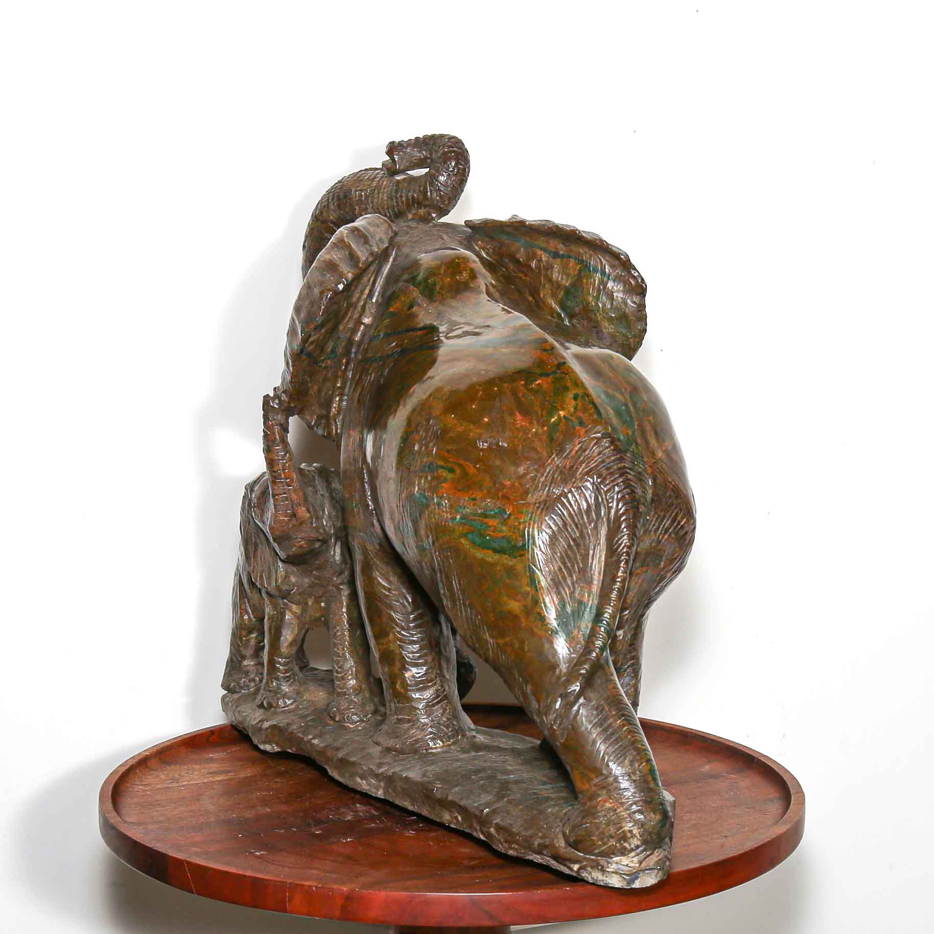Green stone sculpture of African elephant with baby