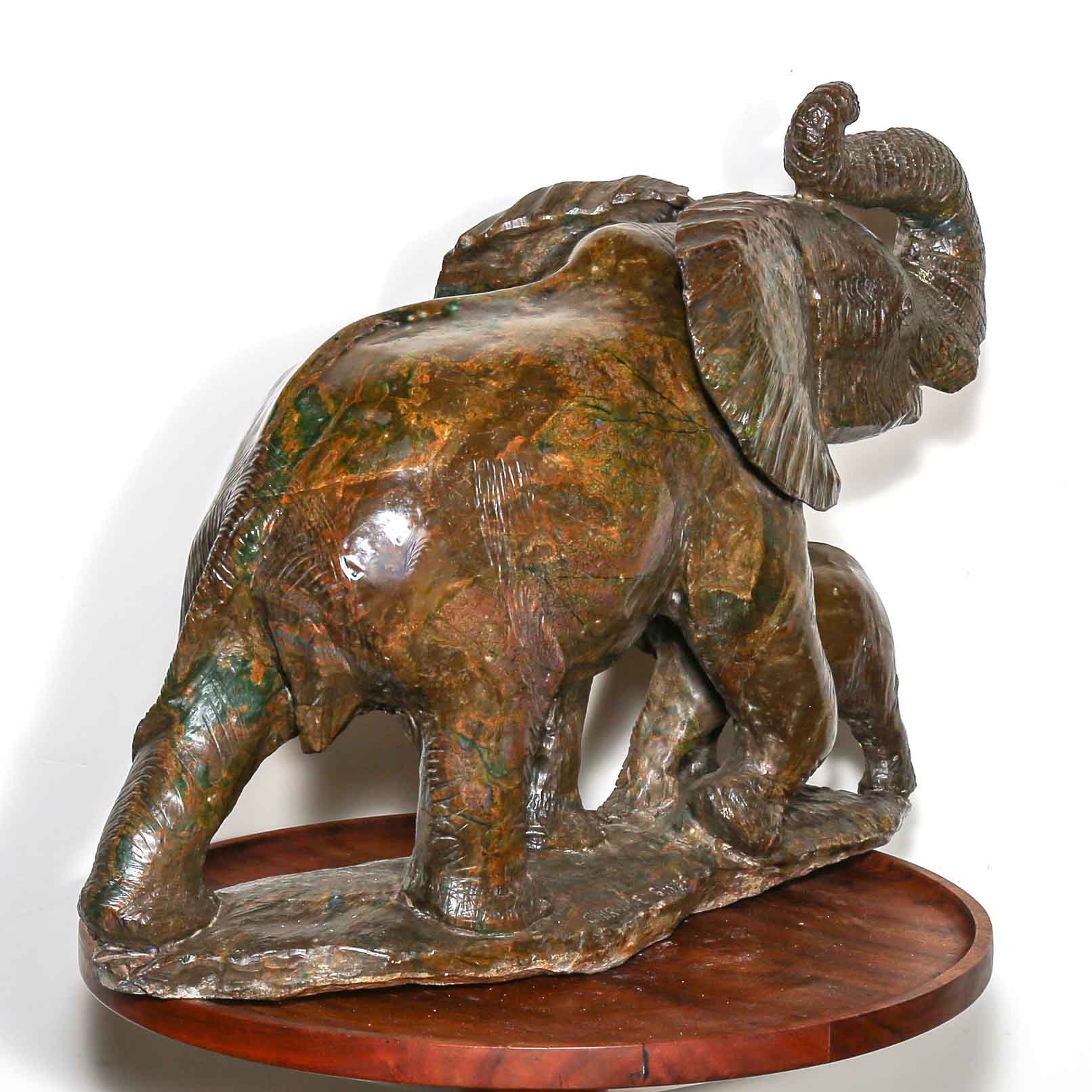 Green stone sculpture of African elephant with baby