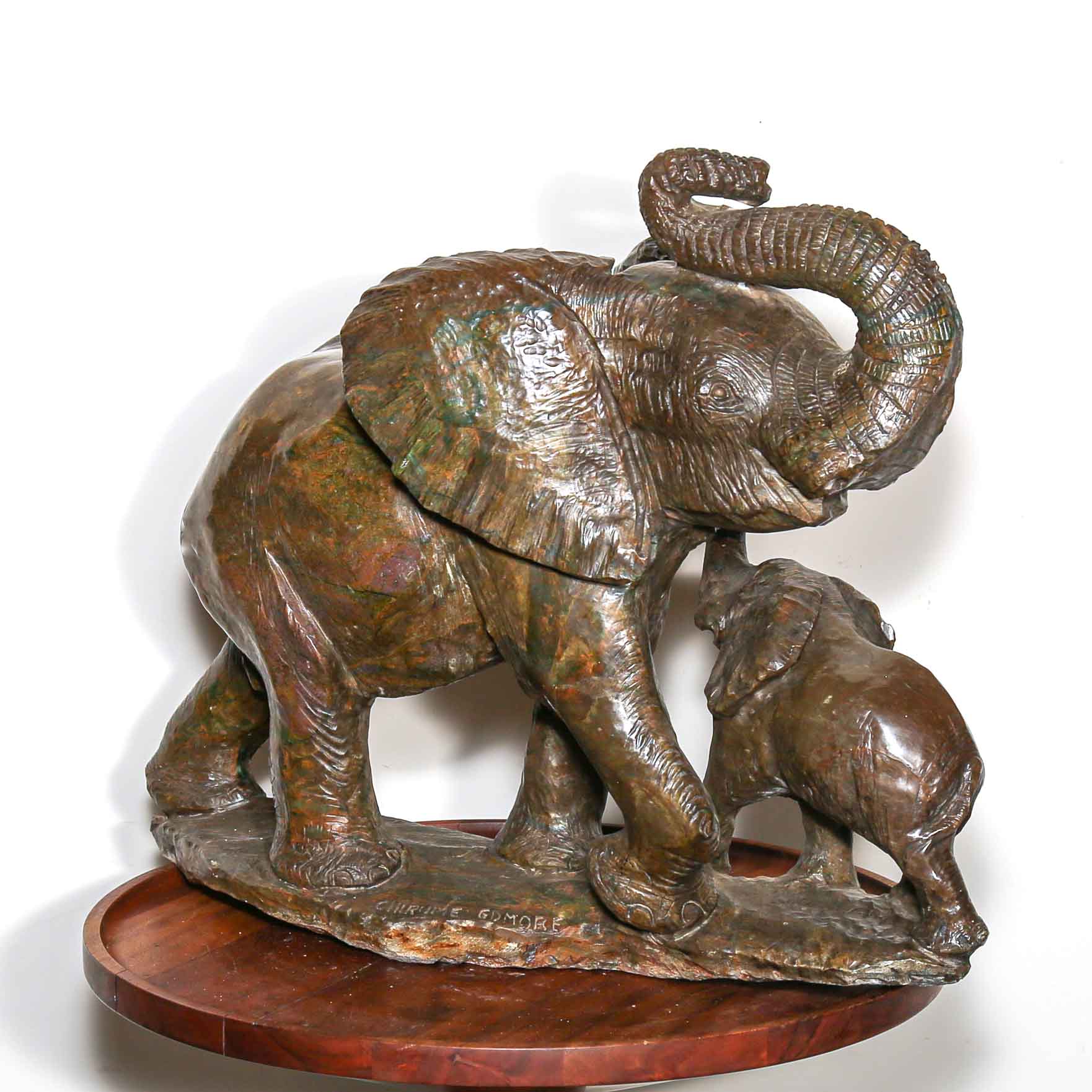 Green stone sculpture of African elephant with baby