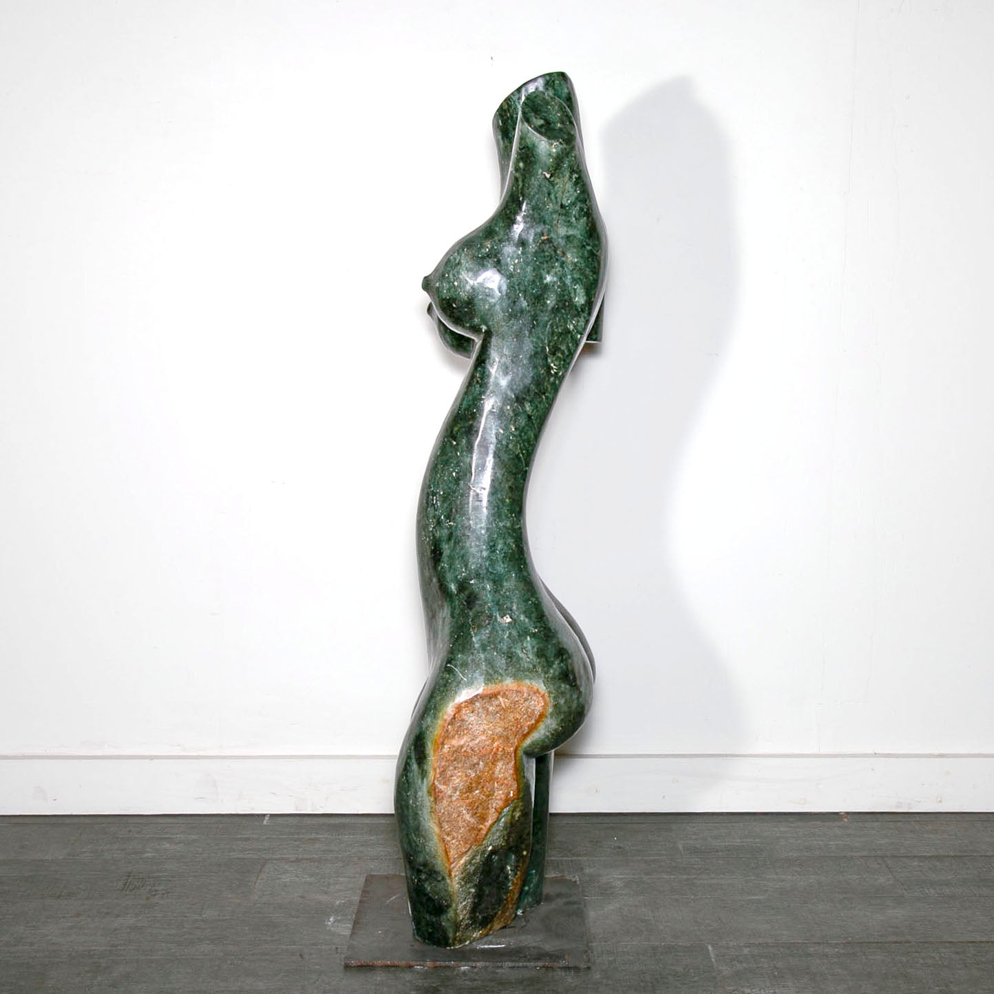 green stone carving of a woman