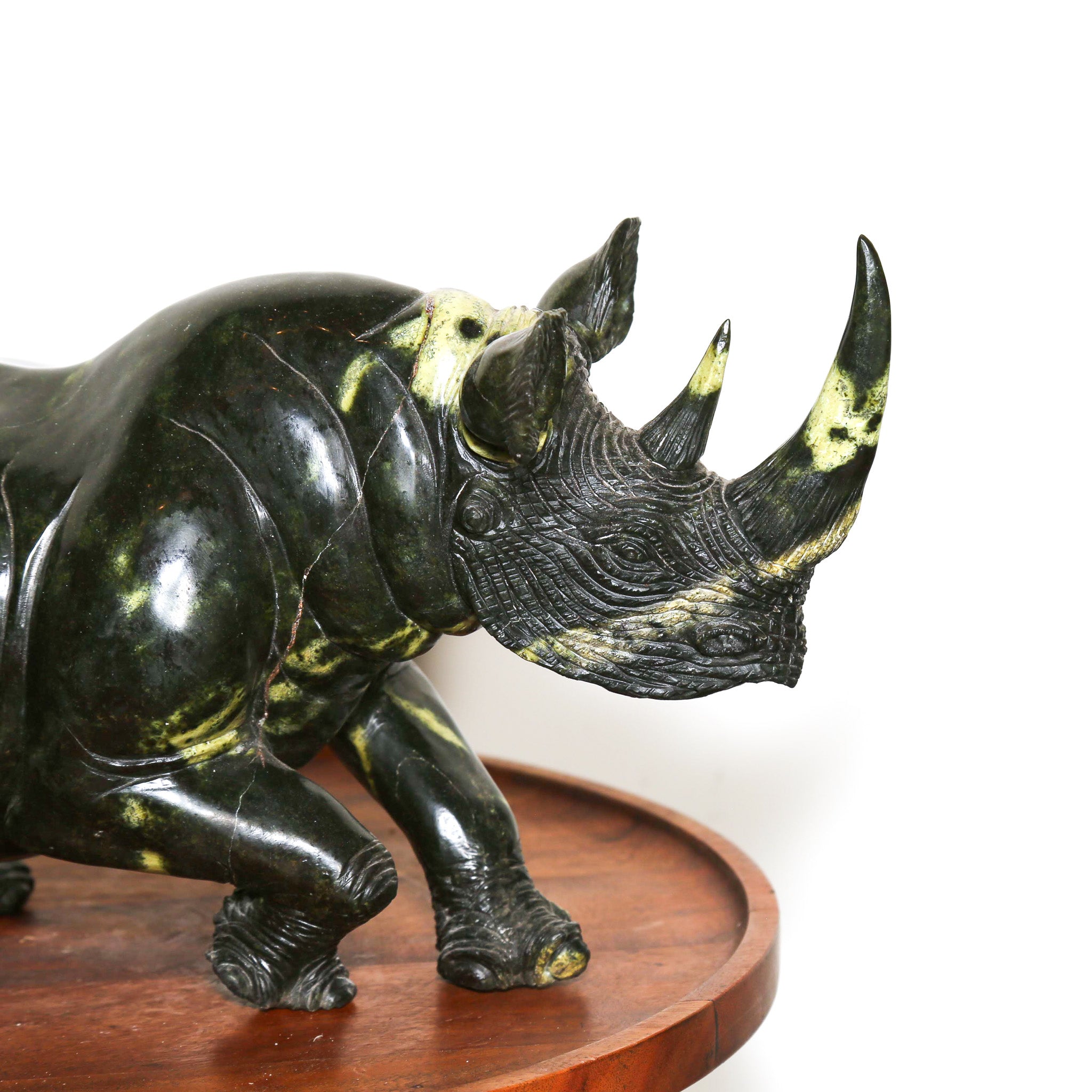 dark and light green stone rhino sculpture