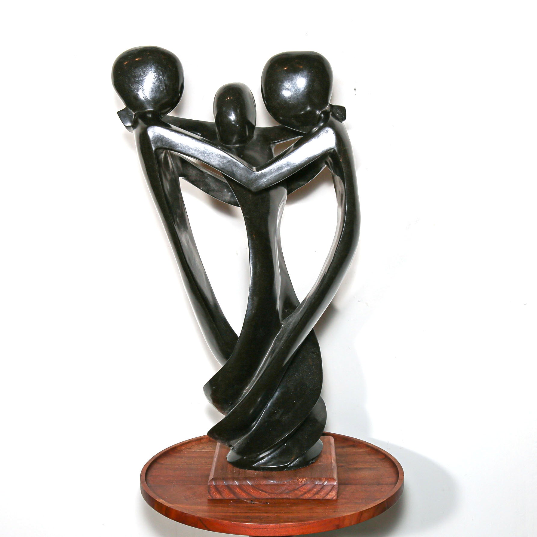 Black Sculpture of three family members hugging